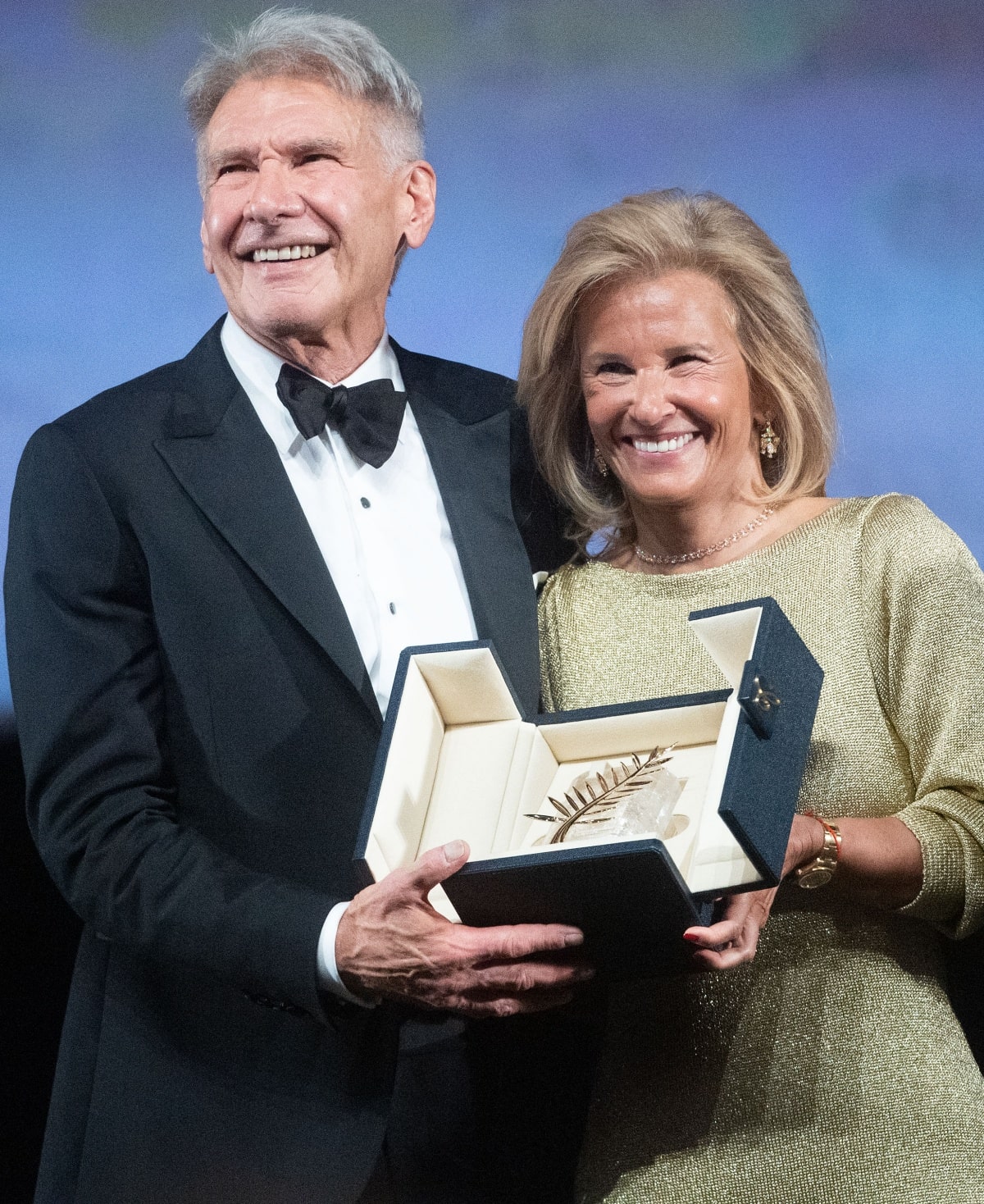 Harrison Ford smiles proudly as he accepts the honorary Palme d’Or from Cannes Film Festival president Iris Knobloch, celebrating his decades-long cinematic legacy