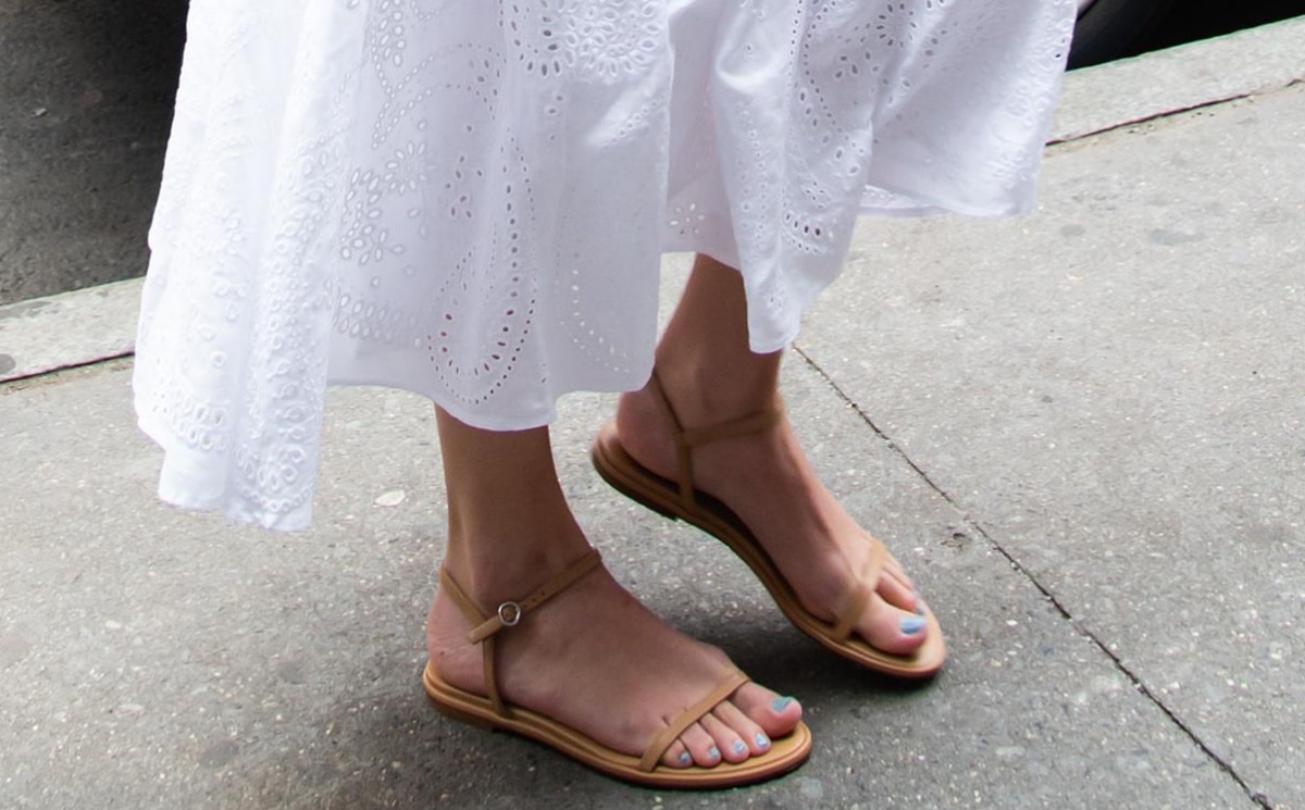 Taylor Swift steps out in Aeyde Nettie hazelnut nappa leather sandals, perfectly complementing her fresh pastel blue pedicure for a chic, effortless summer look