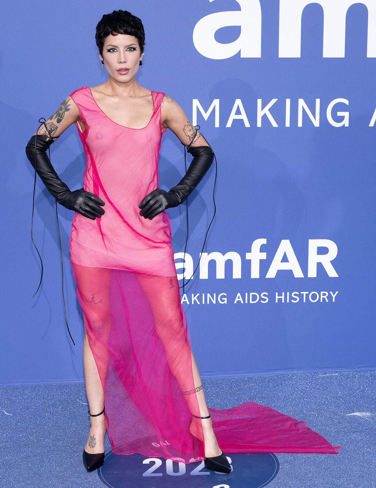 Halsey made a bold statement in a sheer pink Givenchy dress styled with black leather opera gloves and sleek ankle-strap pumps