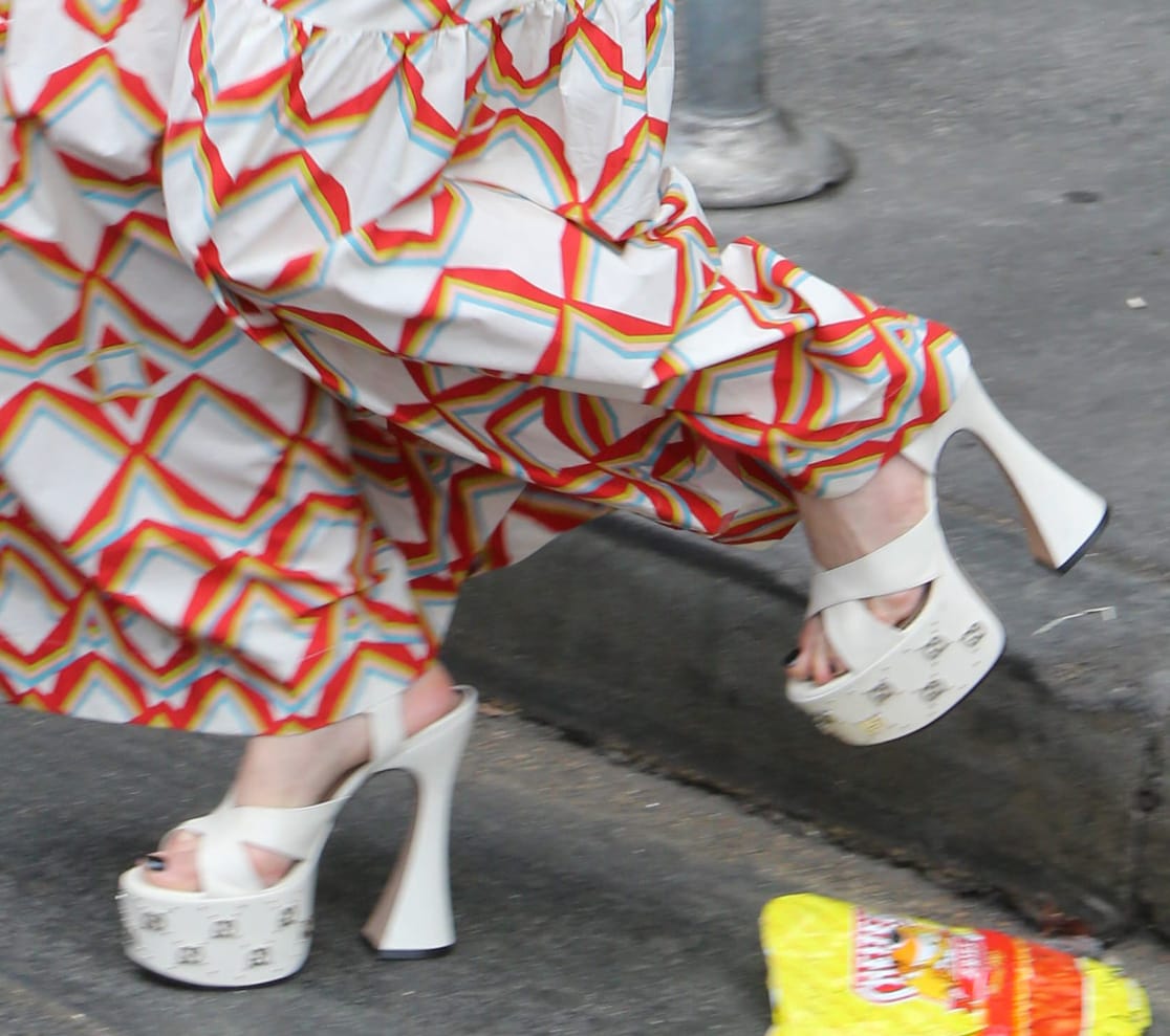 Jennifer Lopez grounded her vibrant La DoubleJ maxi dress with towering white Gucci platform sandals finished with signature silver GG studs and sculptural flared heels