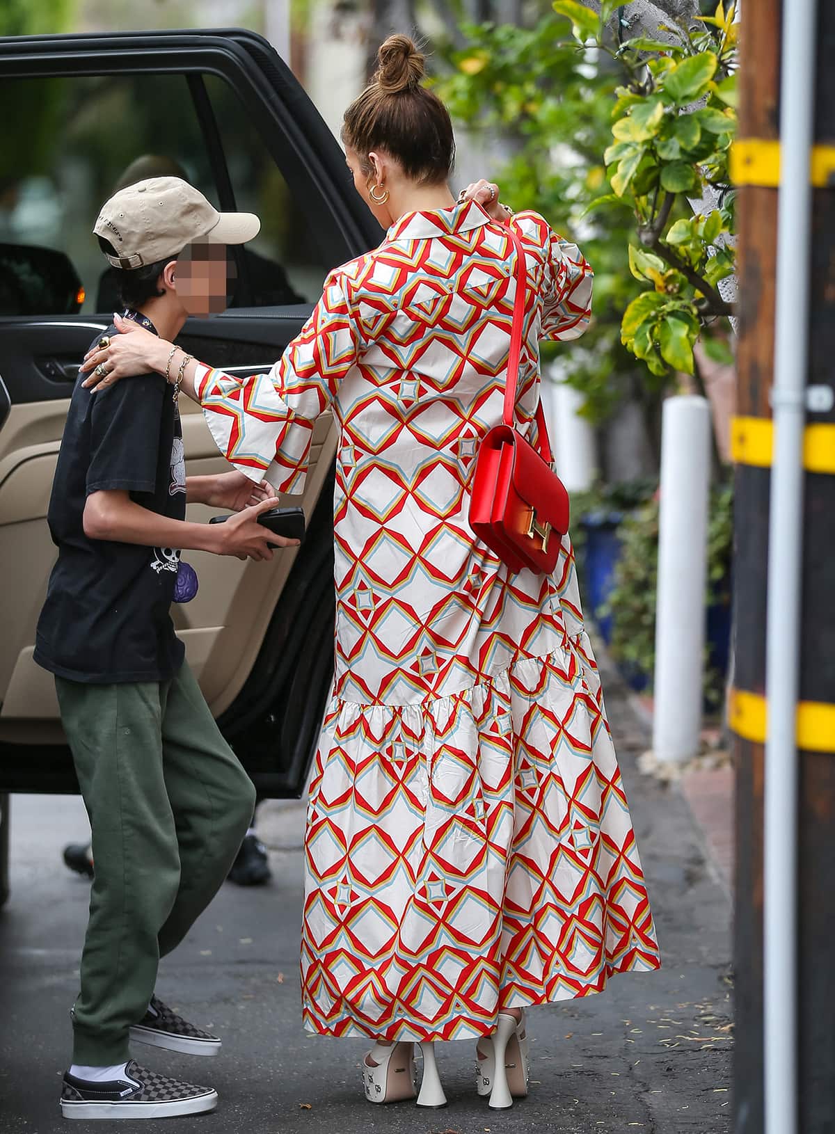 Jennifer Lopez steps out for lunch with her twins in Los Angeles on June 10, 2023, pairing her colorful La DoubleJ maxi shirtdress with towering white Gucci platform sandals and a bright red Hermès Constance bag