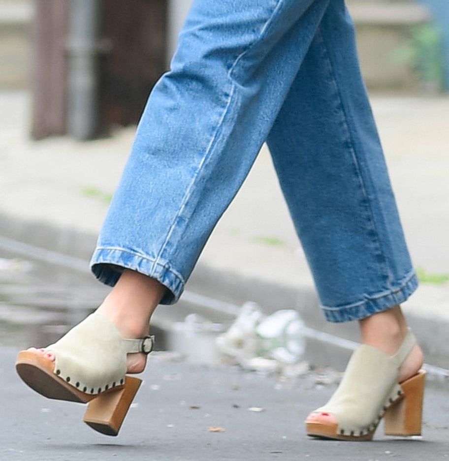 Olivia Wilde pairs her denim jumpsuit with Sézane high-heeled slingback clogs, adding structure and height to her off-duty look