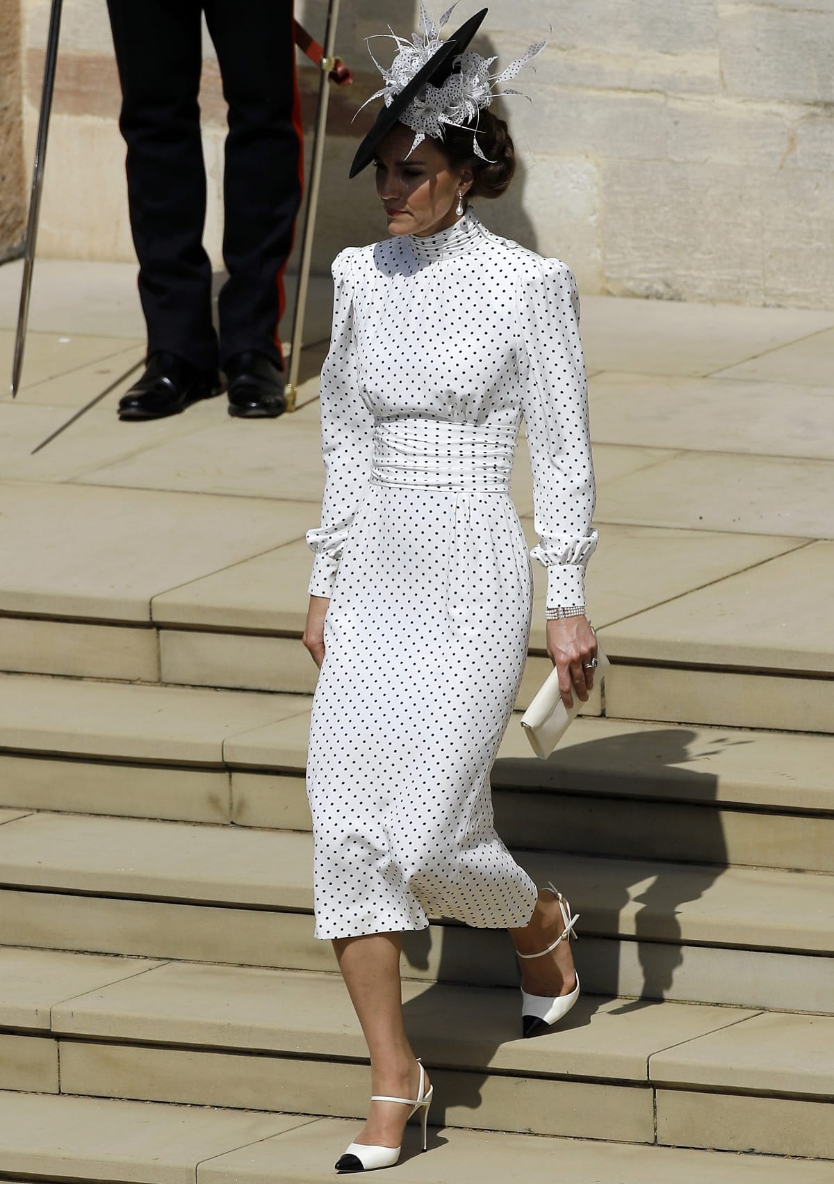 Catherine, Princess of Wales carrying a clutch from Strathberry and wearing two-tone heels from Jennifer Chamandi to complete her elegant look