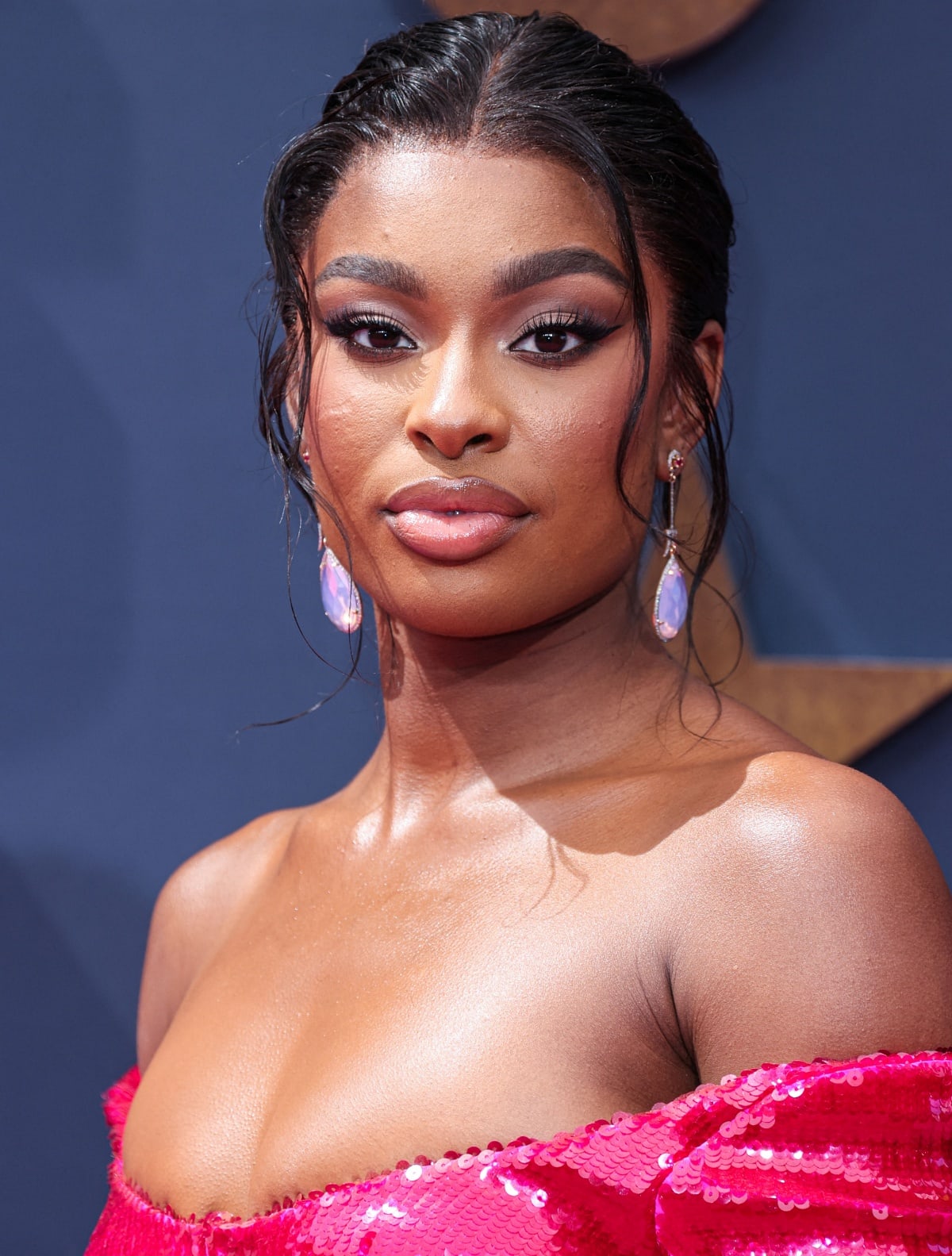 Coco Jones decked out in Hanut Singh jewelry, including large pale purple diamond drop earrings