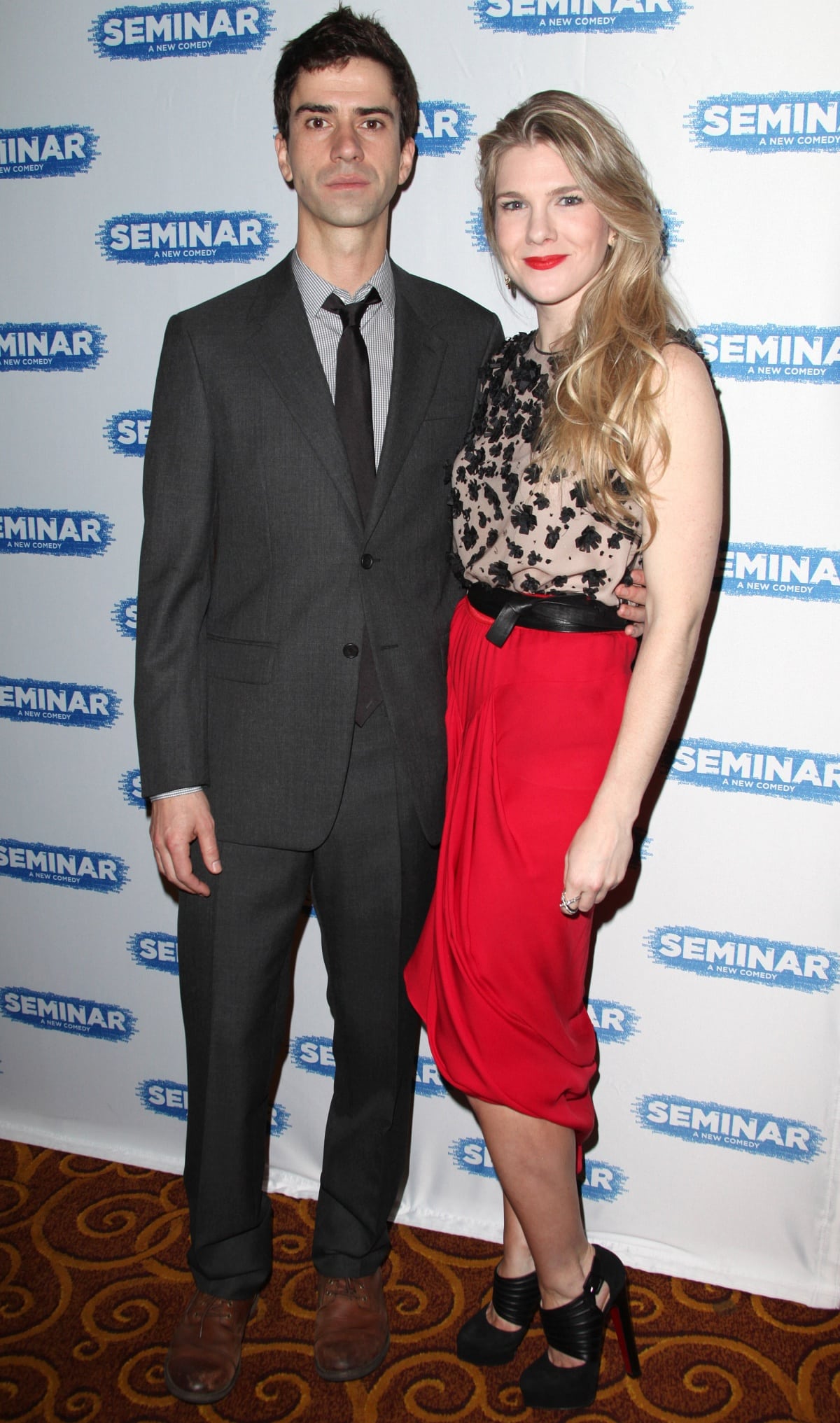 Lily Rabe turned heads in a sheer floral-embroidered top, bold red draped skirt, and towering black platform heels while attending the Seminar Opening Night After Party with Hamish Linklater in New York City
