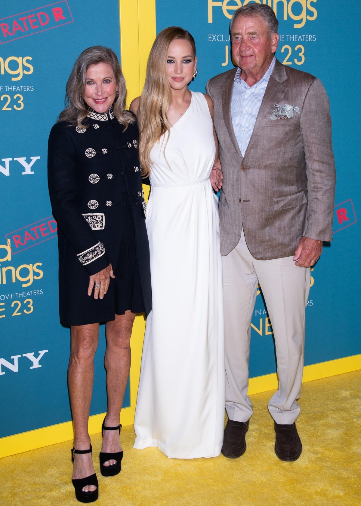 Flanked by her parents, she lit up the carpet in a draped white Christian Dior Pre-Fall 2023 gown and gleaming gold Manolo Blahnik Chaos sandals