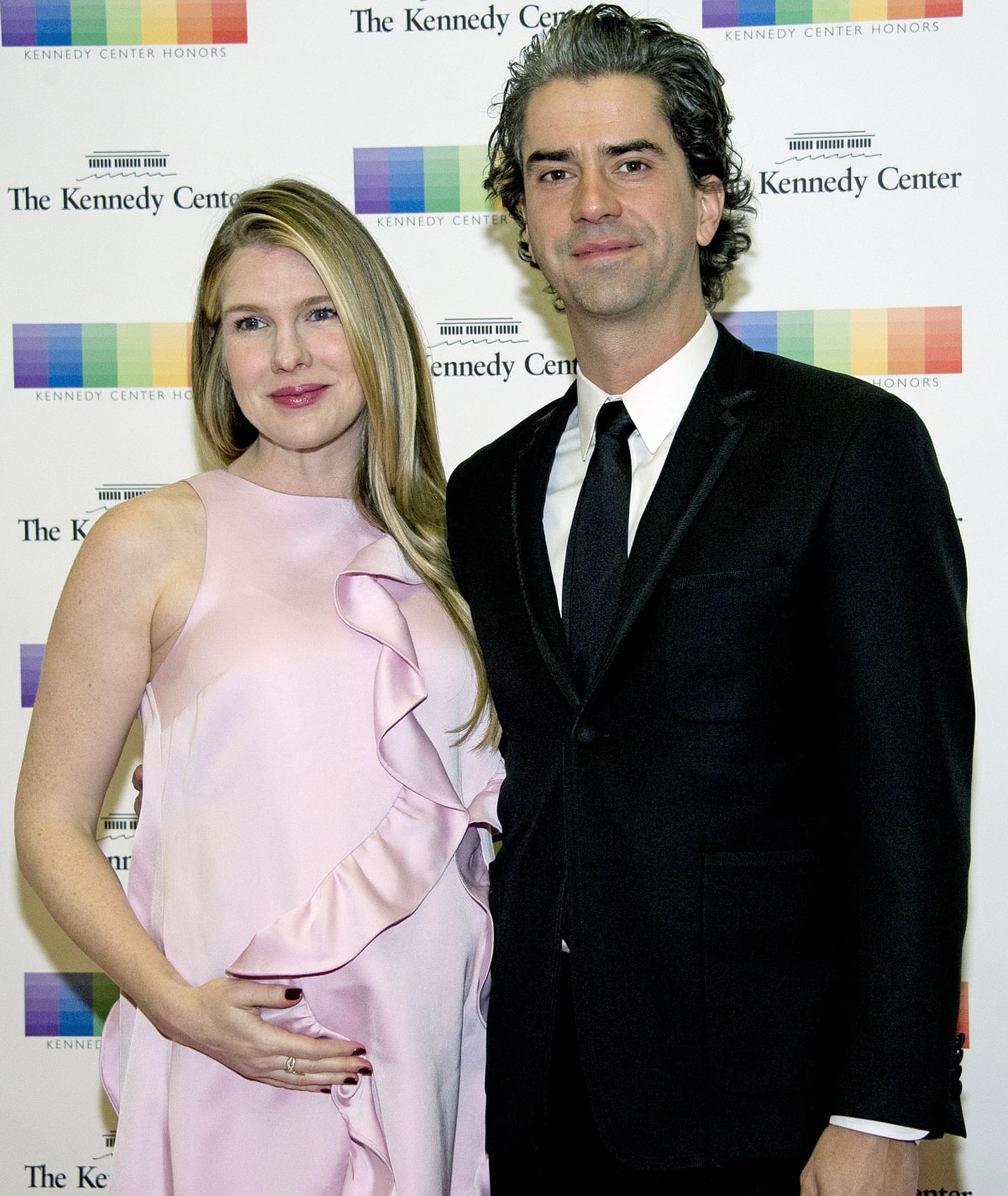 A pregnant Lily Rabe glowed in a soft pink ruffled gown while attending the 2016 Kennedy Center Honors Formal Artist’s Dinner with Hamish Linklater, who wore a classic black suit and tie
