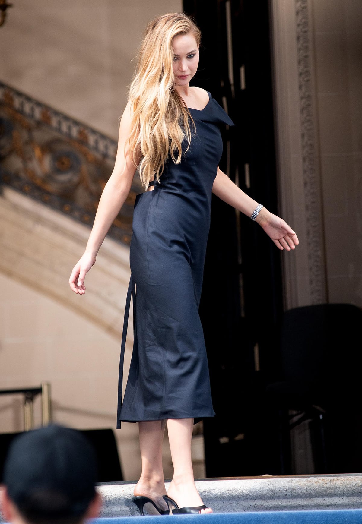 Jennifer Lawrence grounds her sleek The Row midi dress with black Manolo Blahnik open-toe mules, adding understated height and polish to the minimalist look