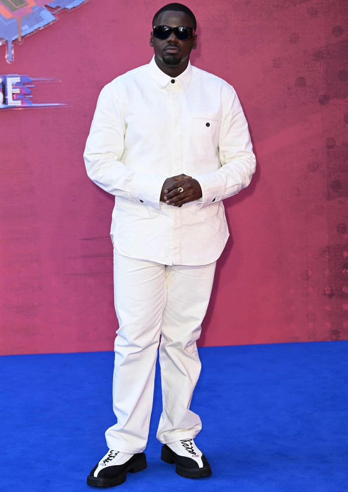 Daniel Kaluuya kept it cool and contemporary at the UK screening of Spider-Man: Across the Spider-Verse in London, wearing an all-white ensemble paired with bold black-and-white leather loafers featuring statement lettering