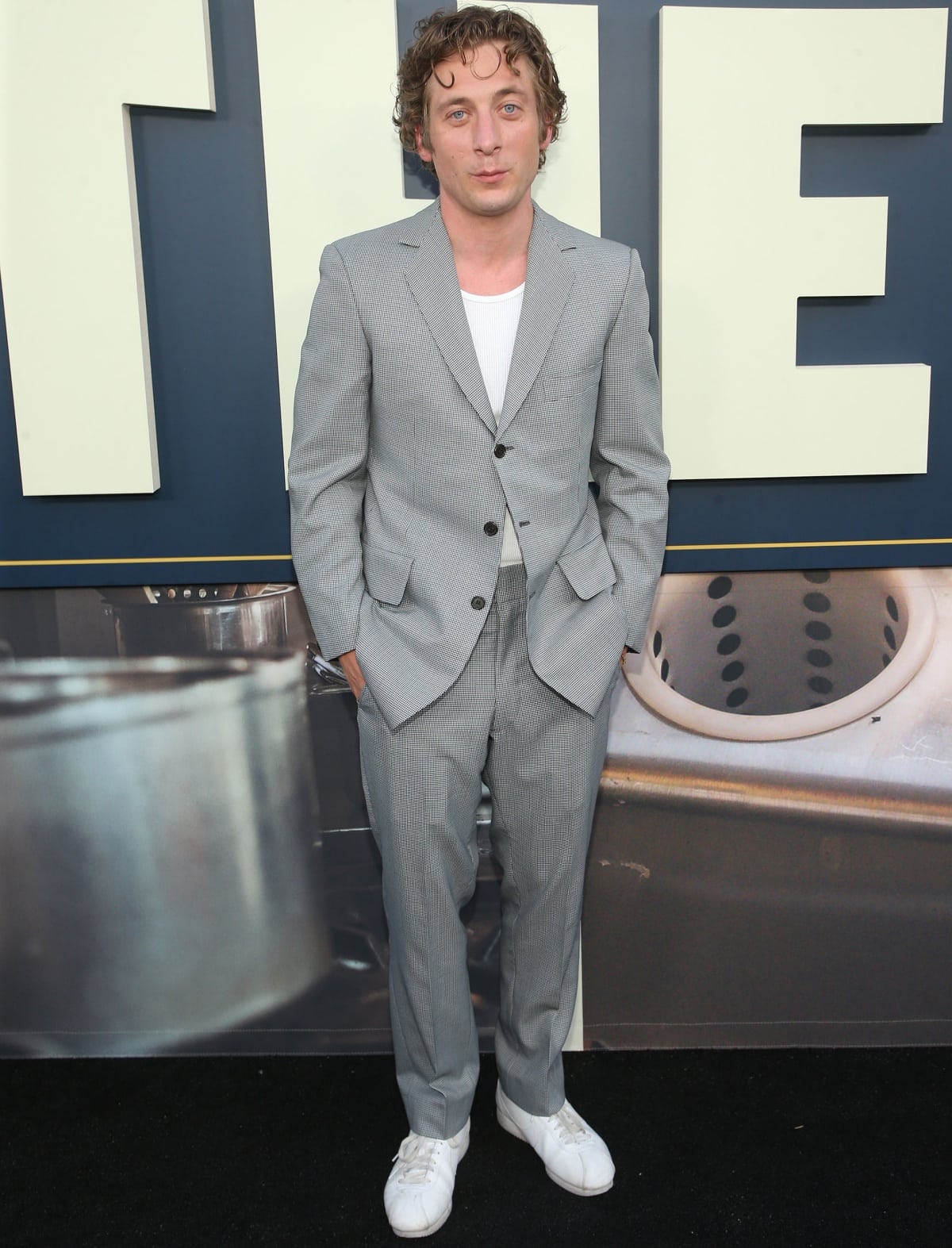 Jeremy Allen White keeps it cool in a light gray suit paired with a white tank and matching sneakers at the premiere of The Bear in Los Angeles on June 20, 2022
