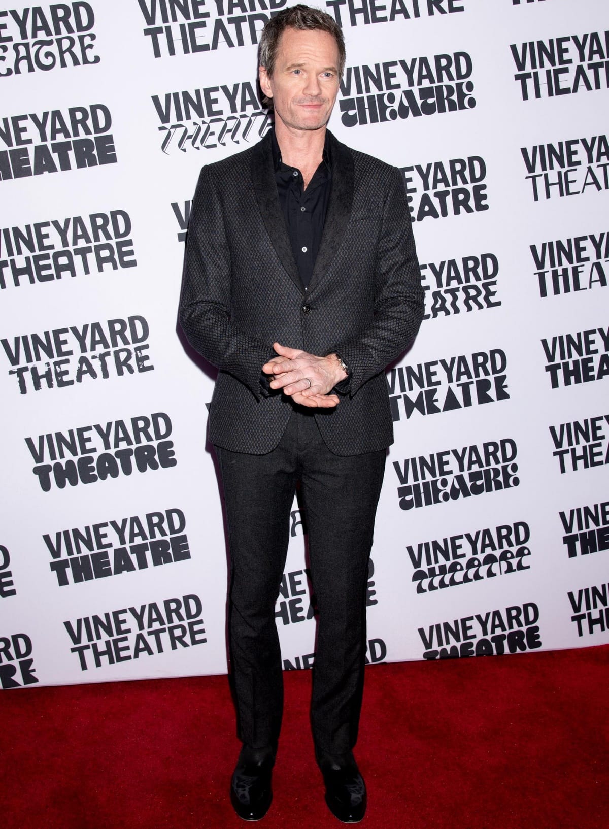 Neil Patrick Harris looked effortlessly polished at the Vineyard Theatre’s 40th Anniversary Gala in New York City, wearing a textured charcoal suit over a black shirt paired with sleek black dress shoes