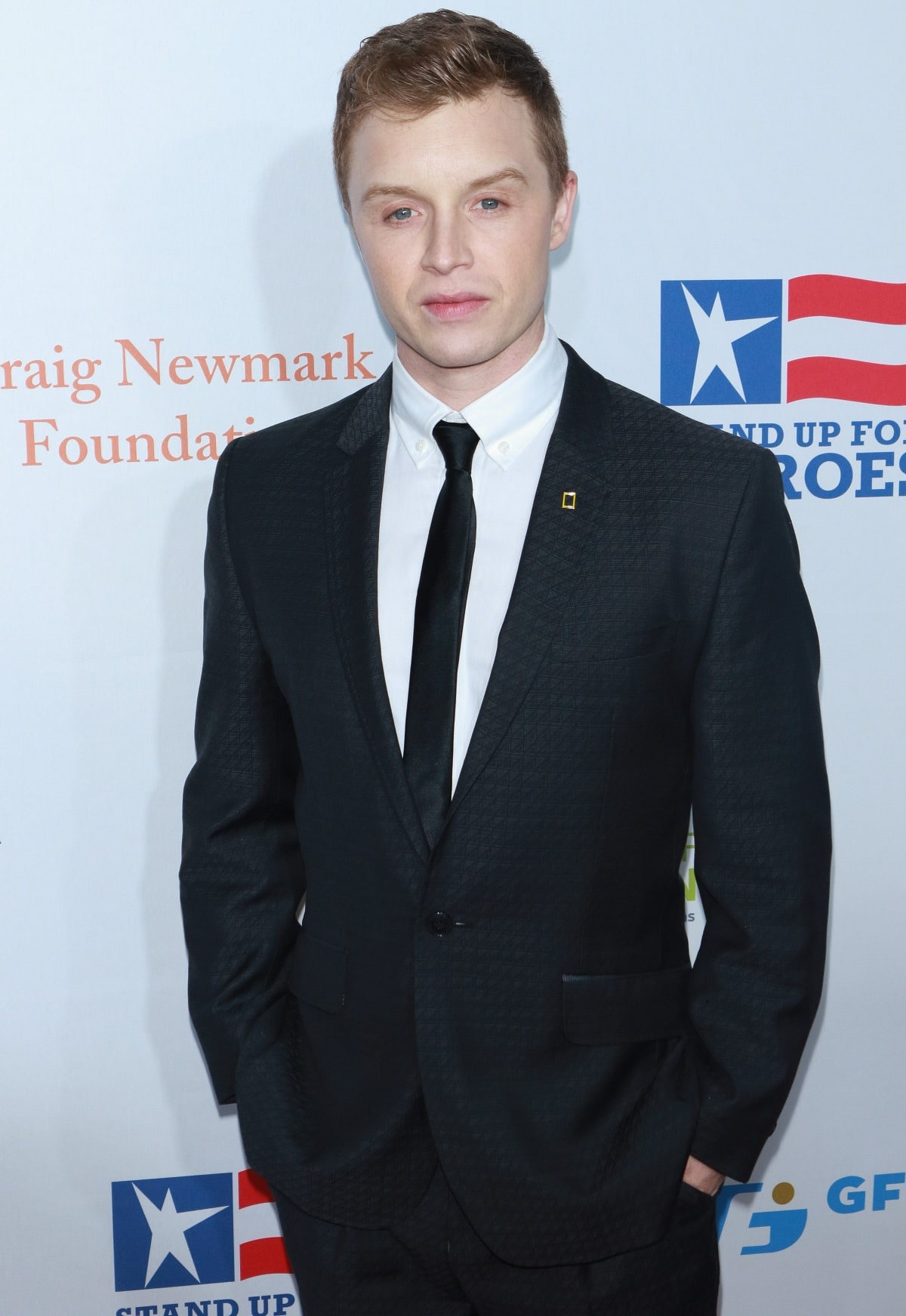 Noel Fisher looks sharp in a subtly textured black suit with a satin tie and crisp white shirt at the Stand Up for Heroes 11th Annual Event in New York City on November 6, 2017