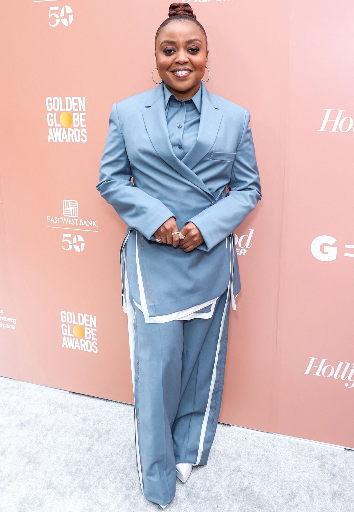 Quinta Brunson suited up in a modern oversized blue two-piece with contrast trim, finishing the look with sleek pointed-toe white pumps at the Golden Globe Awards event