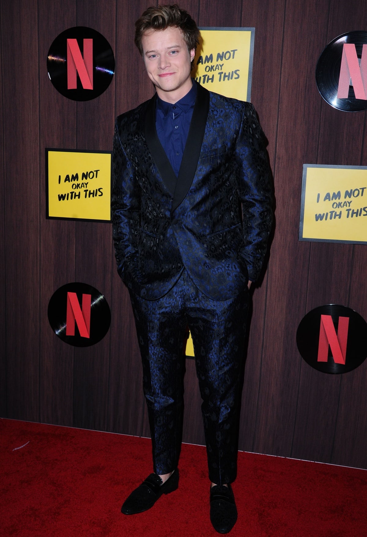 Rudy Pankow makes a dapper statement in a deep blue jacquard tuxedo with black satin lapels, paired with velvet loafers at Netflix’s I Am Not Okay With This premiere