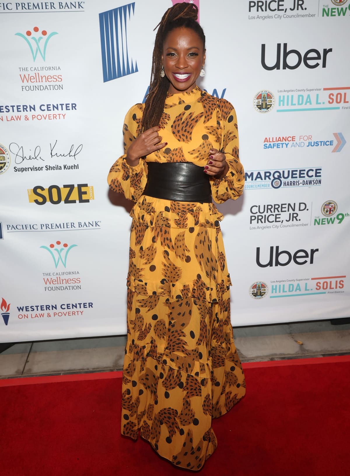 Shanola Hampton radiates confidence in a bold yellow animal-print maxi dress with ruffled details and a wide black leather belt at the A New Way of Life 2022 Gala in Los Angeles on December 4, 2022