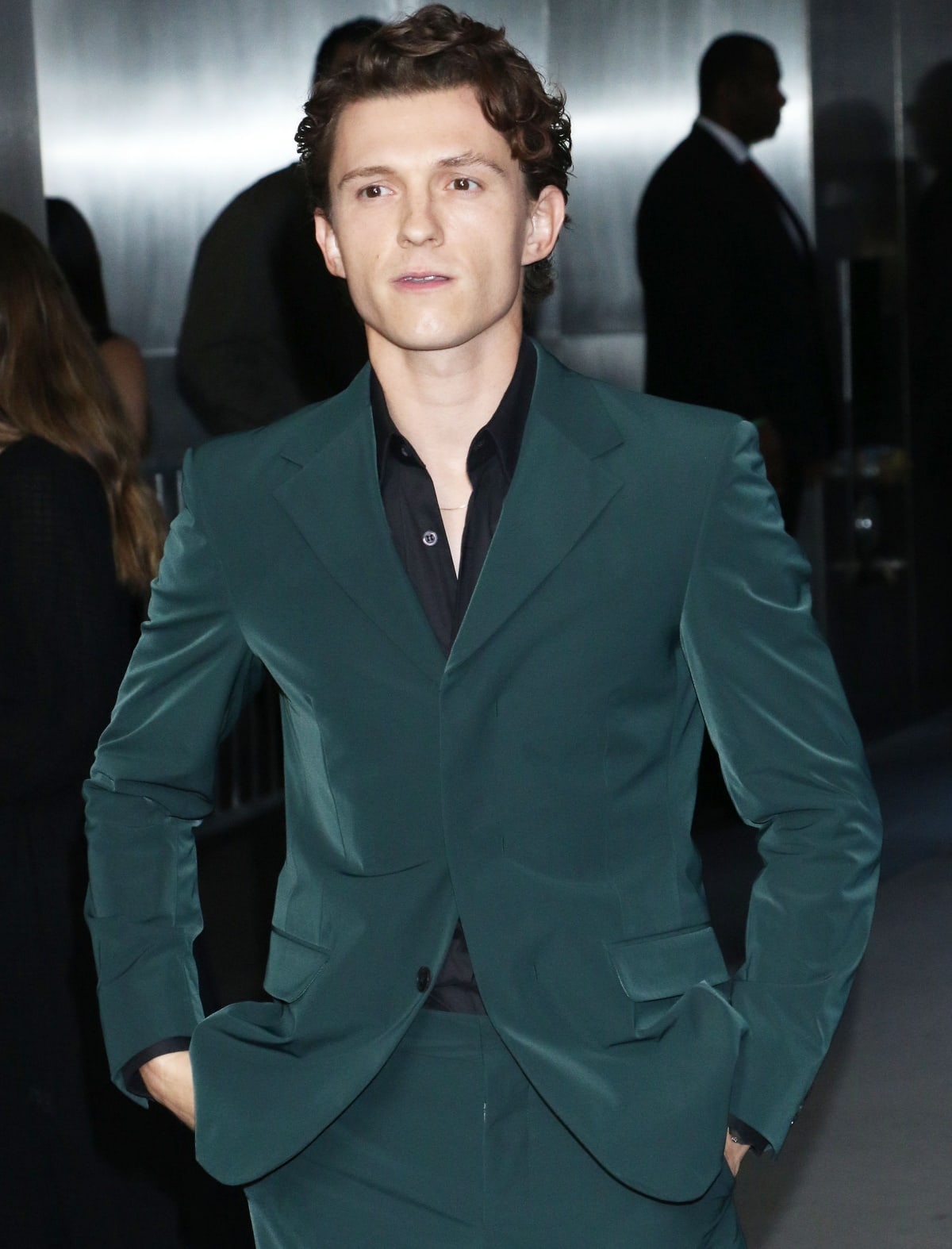 Tom Holland in a sleek green suit, exuding sophistication with a modern twist at the screening of The Crowded Room
