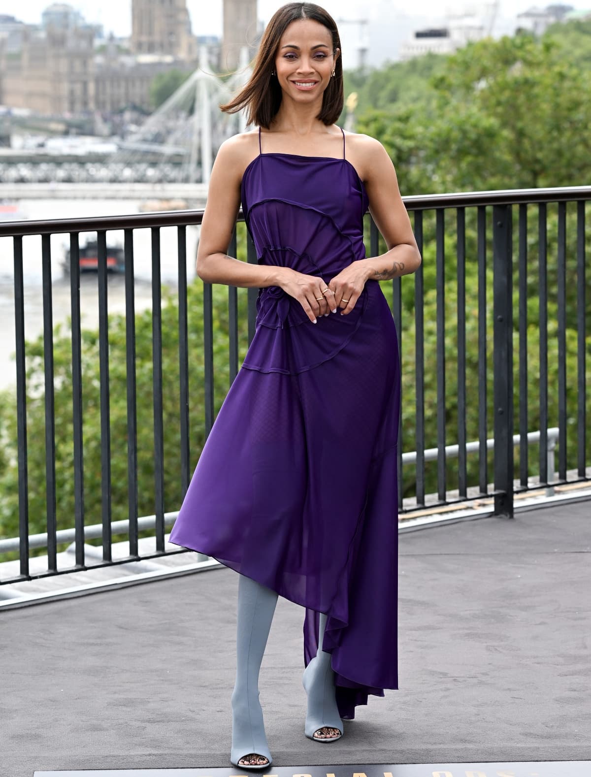Zoe Saldaña looking lovely in a deep purple dress from Victoria Beckham at the photocall for Special Ops: Lioness