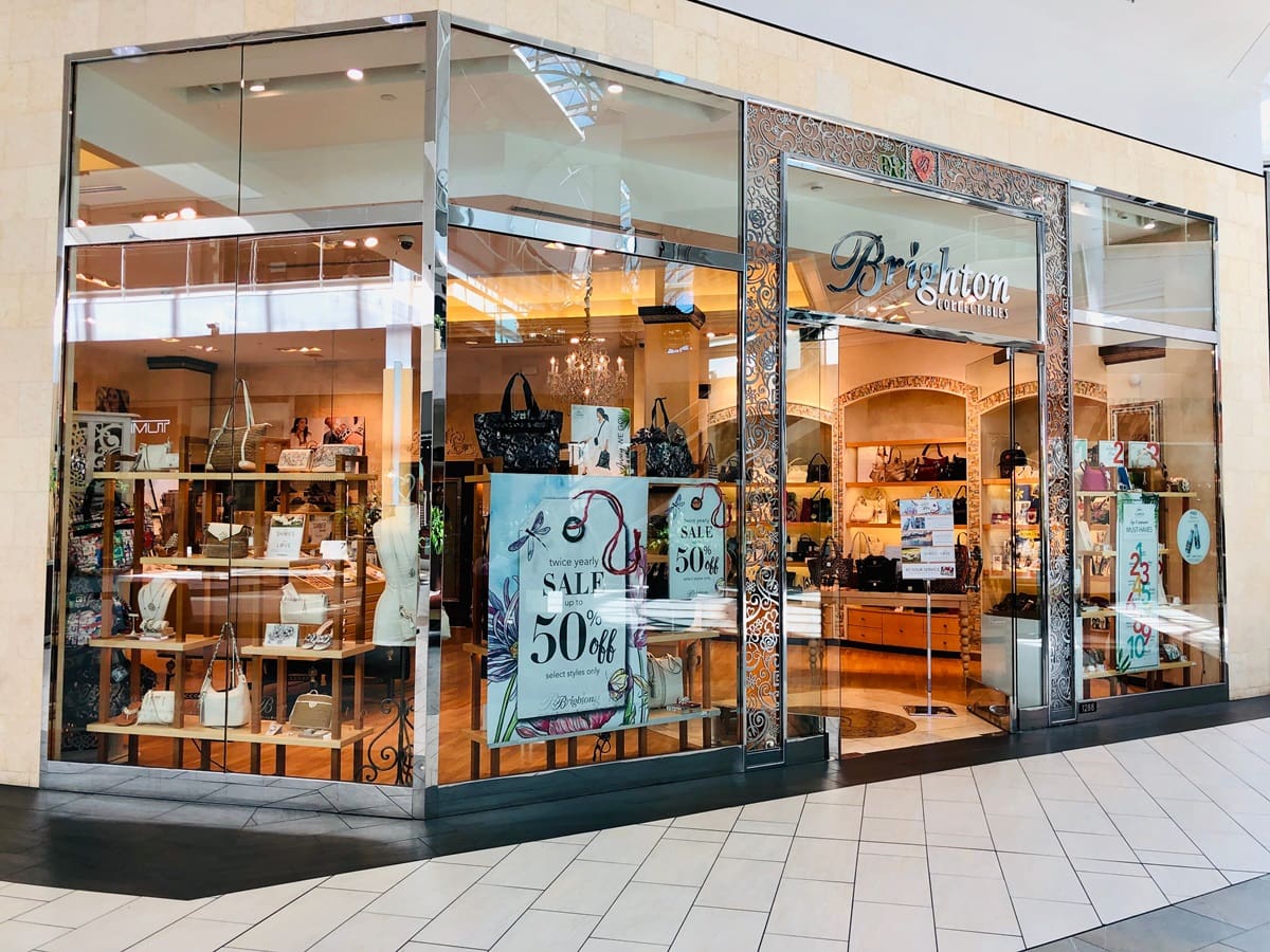 A Brighton Collectibles storefront showcases the brand’s signature handbags and accessories, highlighting its polished, boutique-style shopping experience