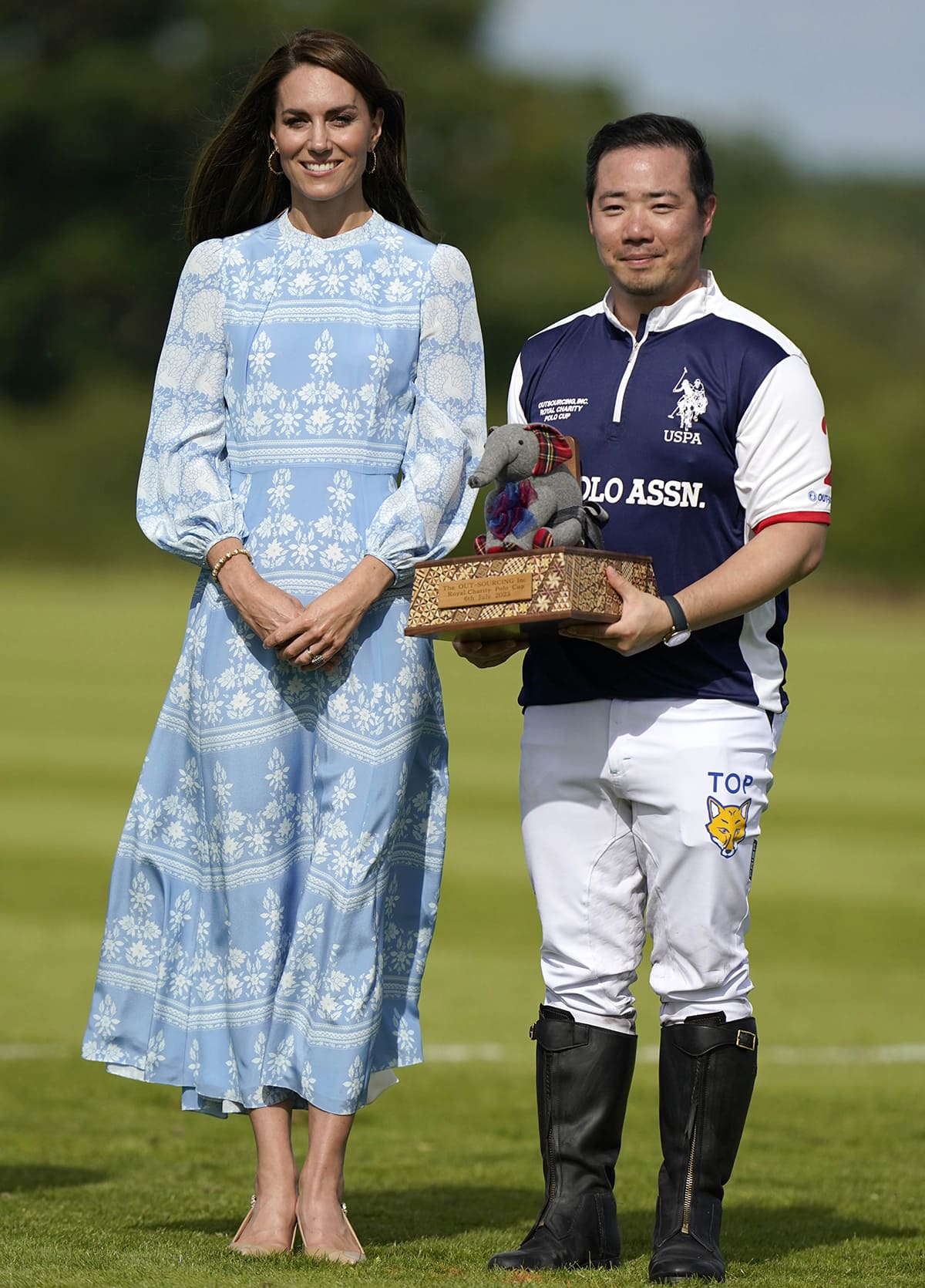 Catherine, Princess of Wales, poses with Thai businessman Aiyawatt Srivaddhanaprabha in a pastel blue Beulah London printed maxi dress