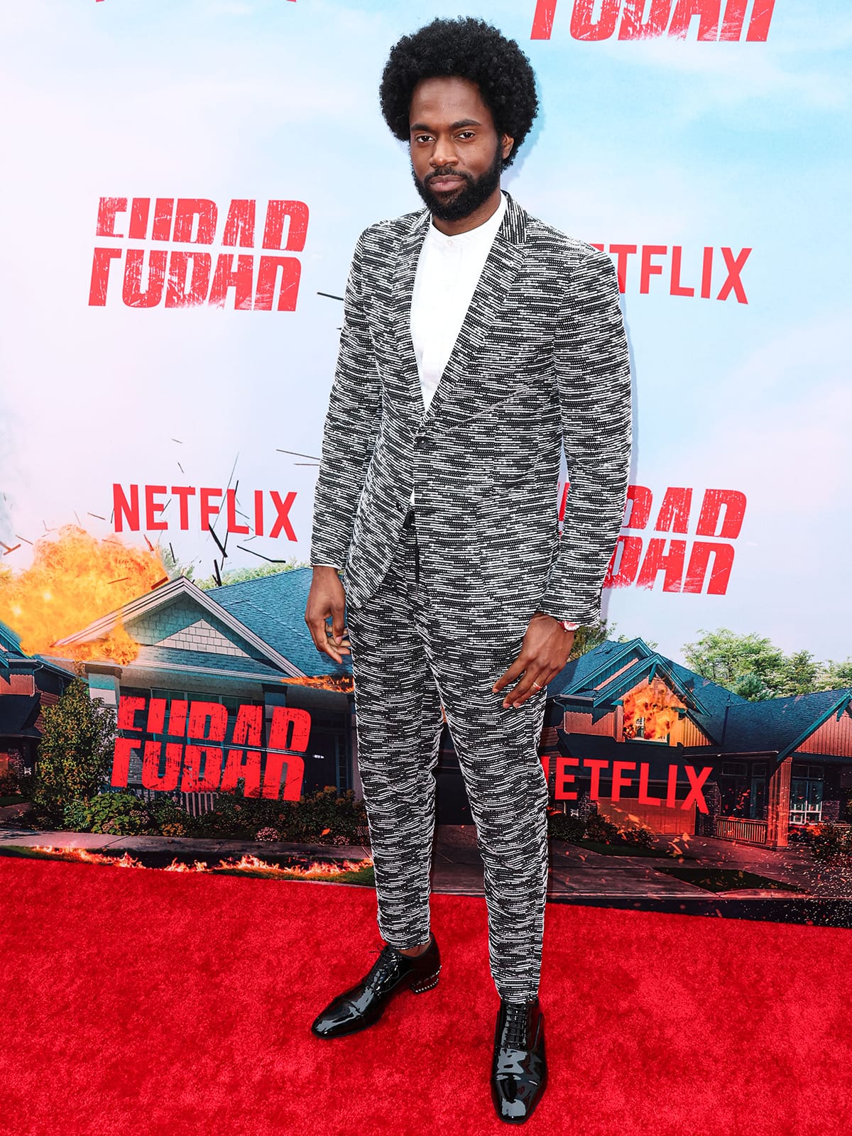 Milan Carter made a bold statement at the FUBAR premiere in a black-and-white suit by Paisley Gray, paired with glossy black dress shoes that added a sleek finish to his standout ensemble