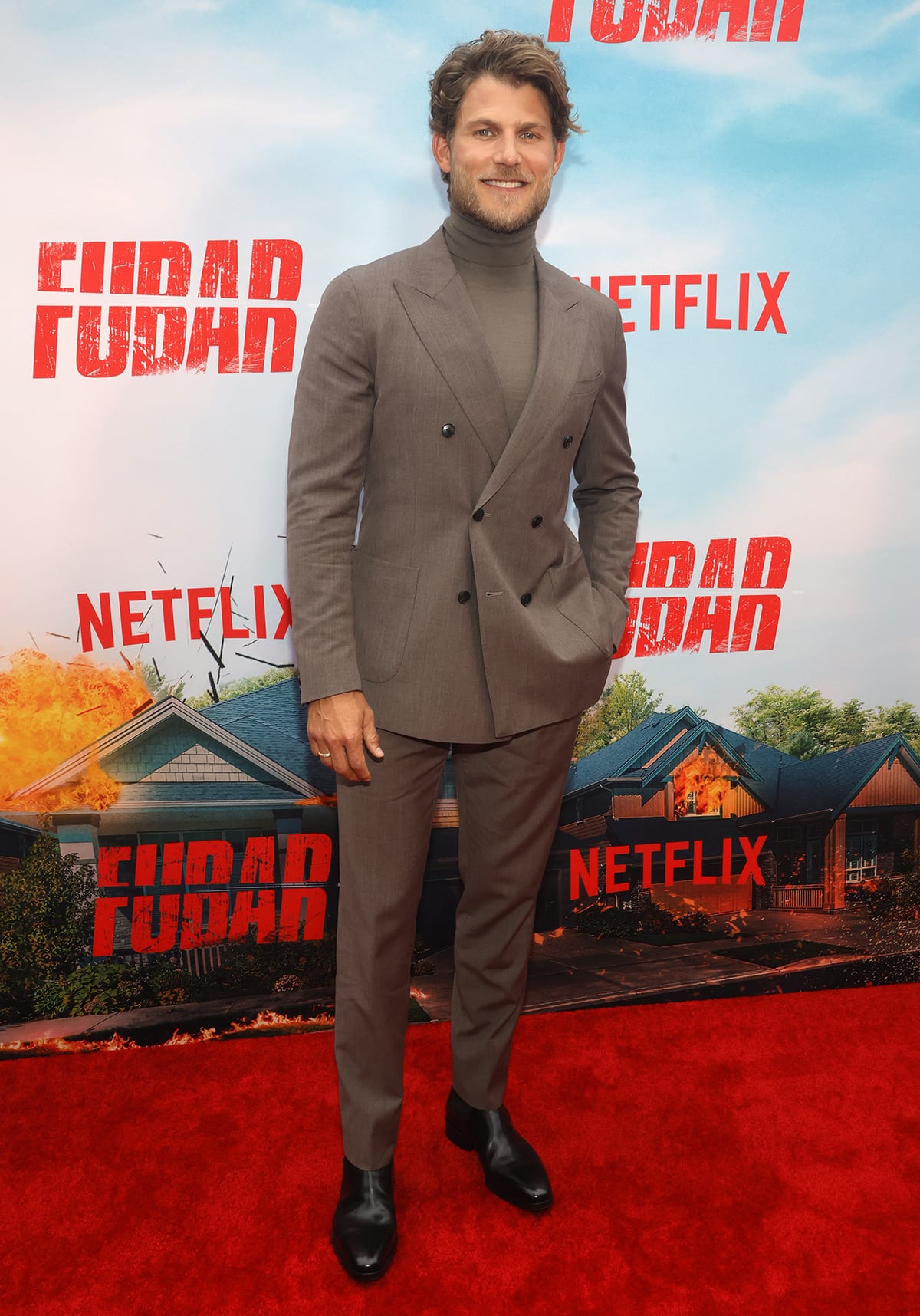 Travis Van Winkle brought polished sophistication to the FUBAR premiere in a taupe Reiss double-breasted suit, styled with a matching turtleneck and sleek black Santoni shoes, accessorized with David Yurman jewelry