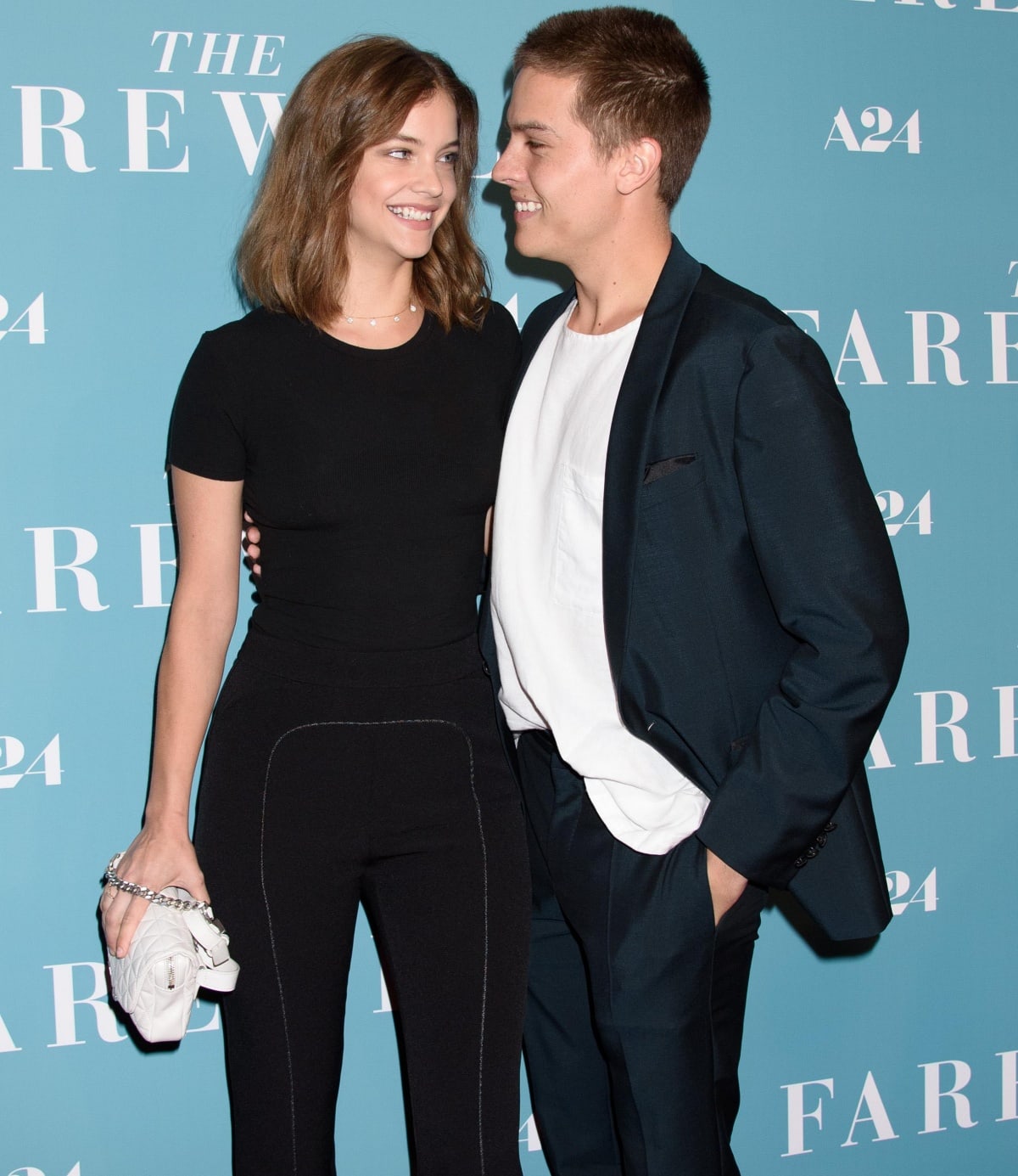 Barbara Palvin keeps it sleek in a fitted black ensemble with contrast stitching and a quilted white clutch, while Dylan Sprouse opts for effortless cool in a navy suit and relaxed white tee at The Farewell screening