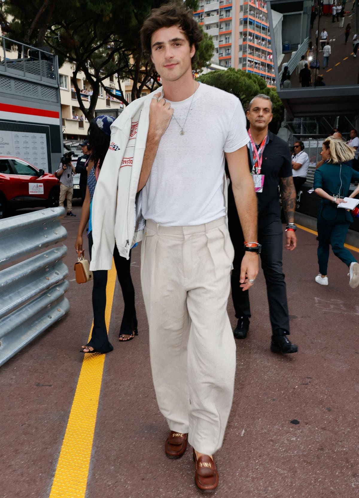 Jacob Elordi elevates his casual Monaco look with tailored trousers and polished brown leather loafers.