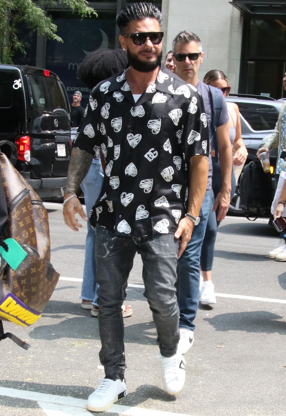 Paul "DJ Pauly D" DelVecchio rocked a casual look in a black DG heart-print shirt, distressed skinny jeans, and white Dolce Gabbana logo sneakers while out and about