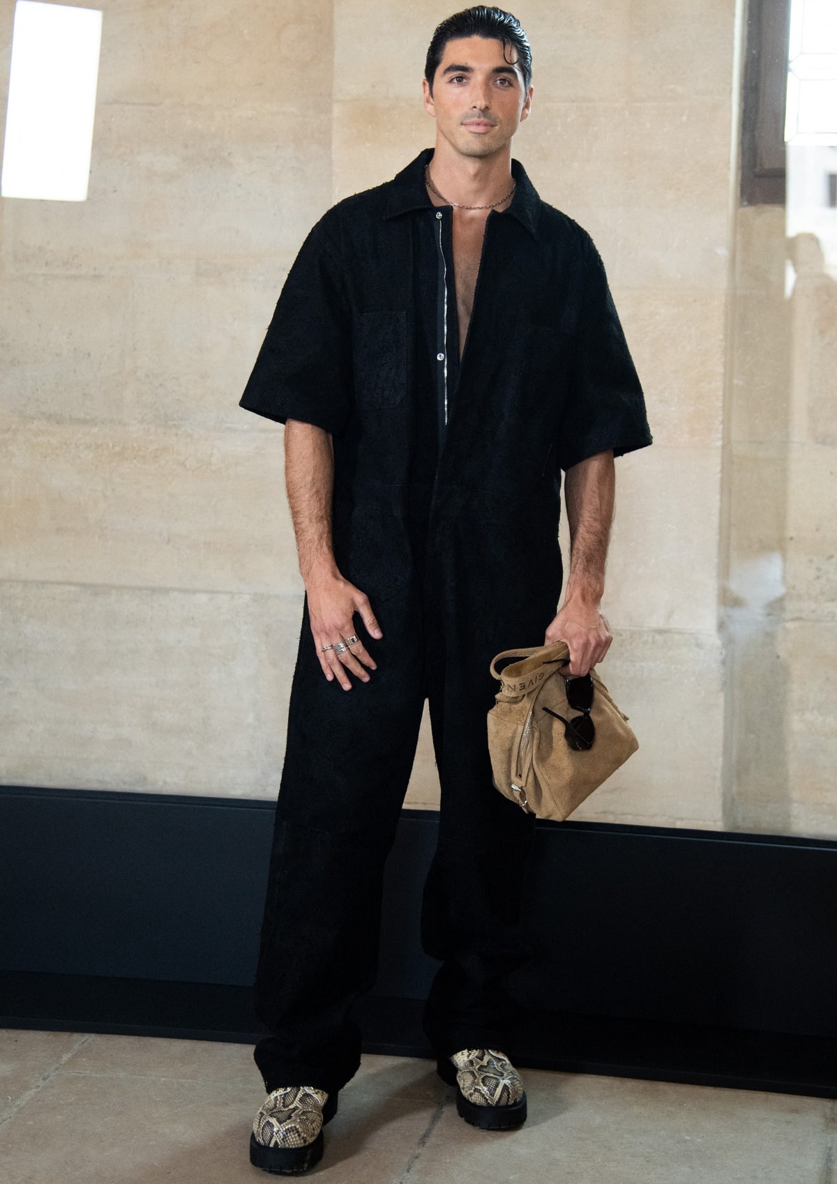 Taylor Zakhar Perez makes a bold statement in a textured jumpsuit punctuated by standout snakeskin platform shoes