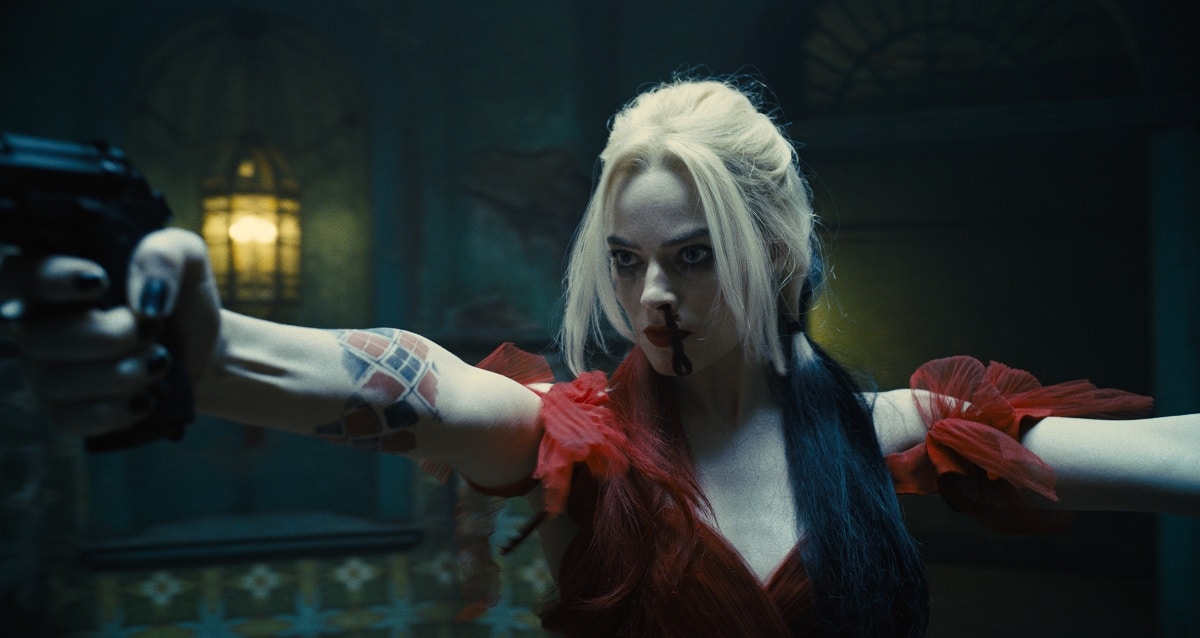 Margot Robbie returns as Harley Quinn in The Suicide Squad (2021), delivering a fierce, action-packed performance in a bold red dress with her signature split-dye hair and deadly precision