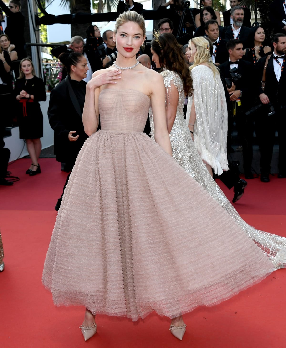 Masterfully styled by Emma Jade Morrison, Martha Hunt epitomized timeless elegance in a delicately textured, peach strapless gown by Jason Wu at the "Club Zero" red carpet during the 76th annual Cannes Film Festival