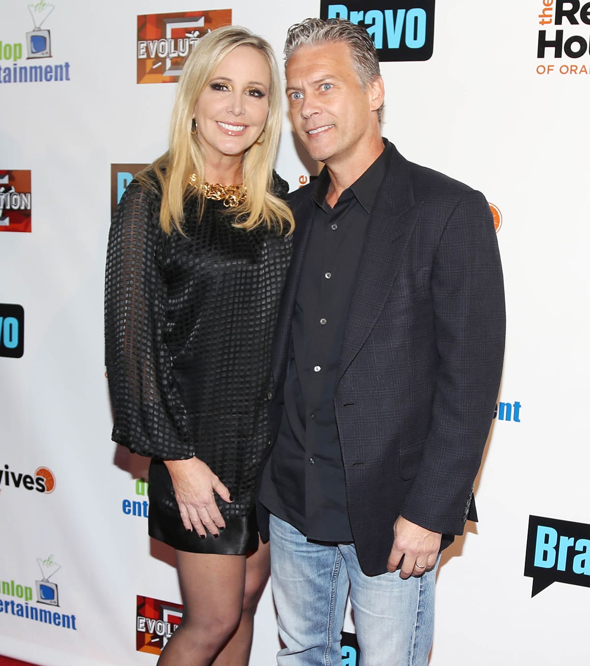 Shannon Beador keeps it classic in a textured black mini dress and sheer tights as she poses on the red carpet with then-husband David Beador