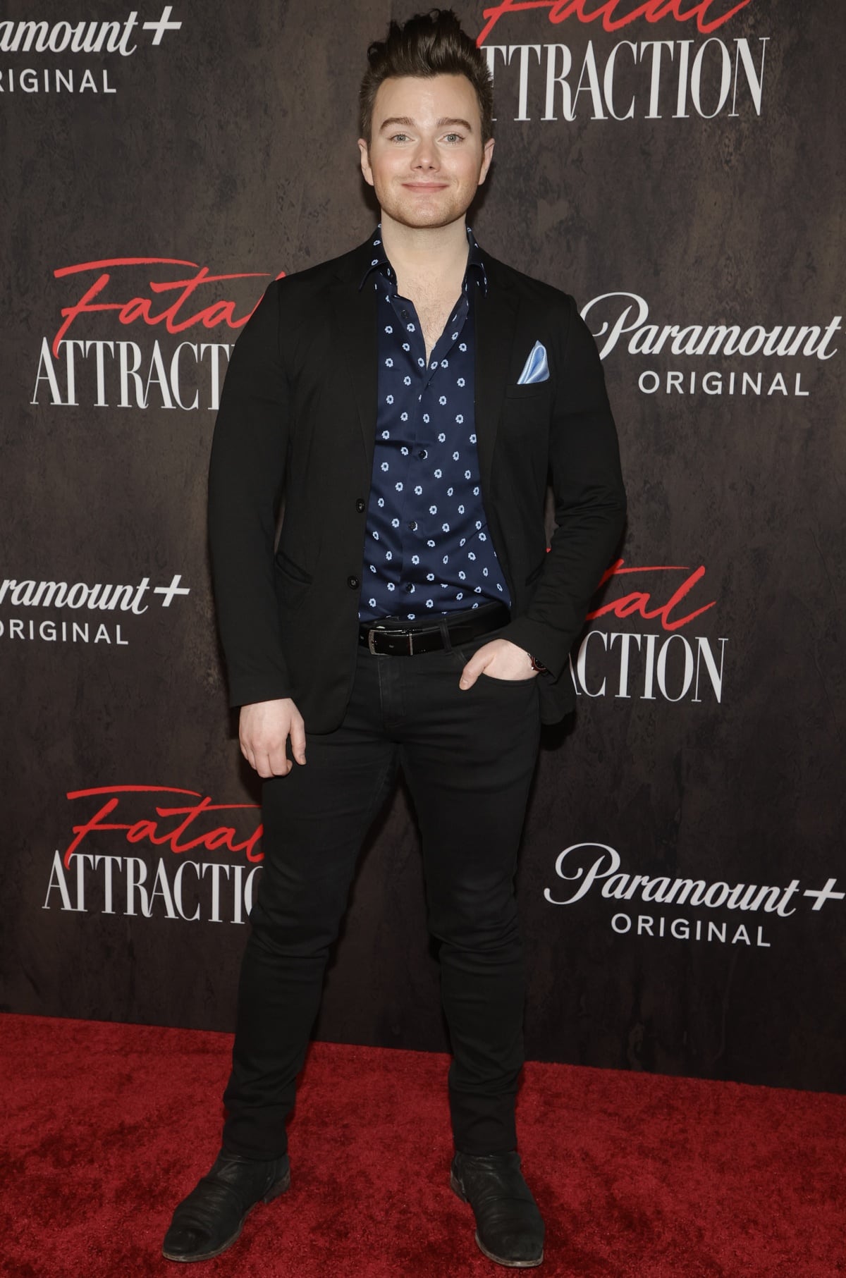 Chris Colfer looked sharp in a patterned navy shirt, black blazer, slim black jeans, and worn-in black boots at the Fatal Attraction premiere