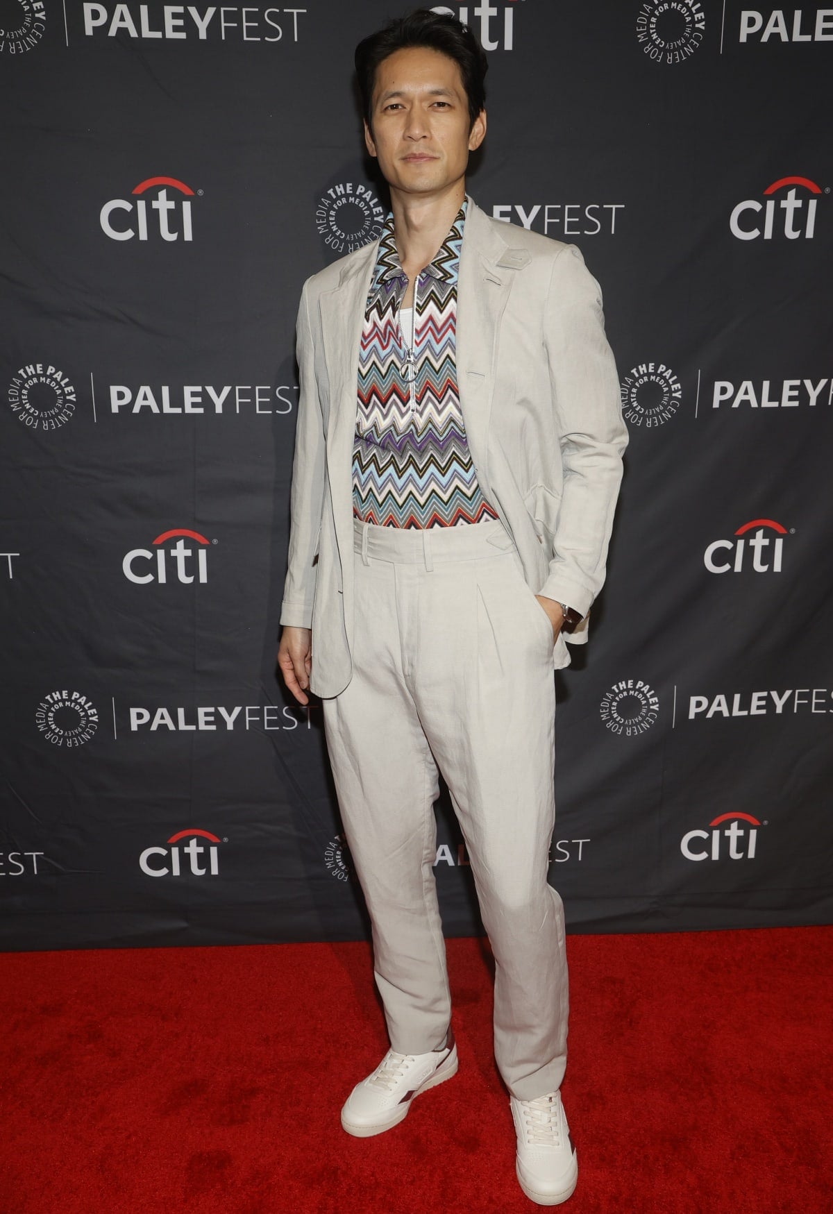 Harry Shum Jr. stepped out in a light beige suit paired with a colorful zigzag-patterned shirt and crisp white sneakers at PaleyFest, blending casual flair with retro sophistication