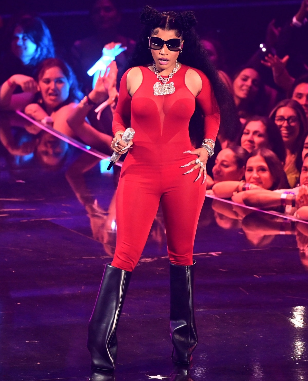 Nicki Minaj changed into a red catsuit styled with black leather knee-high boots
