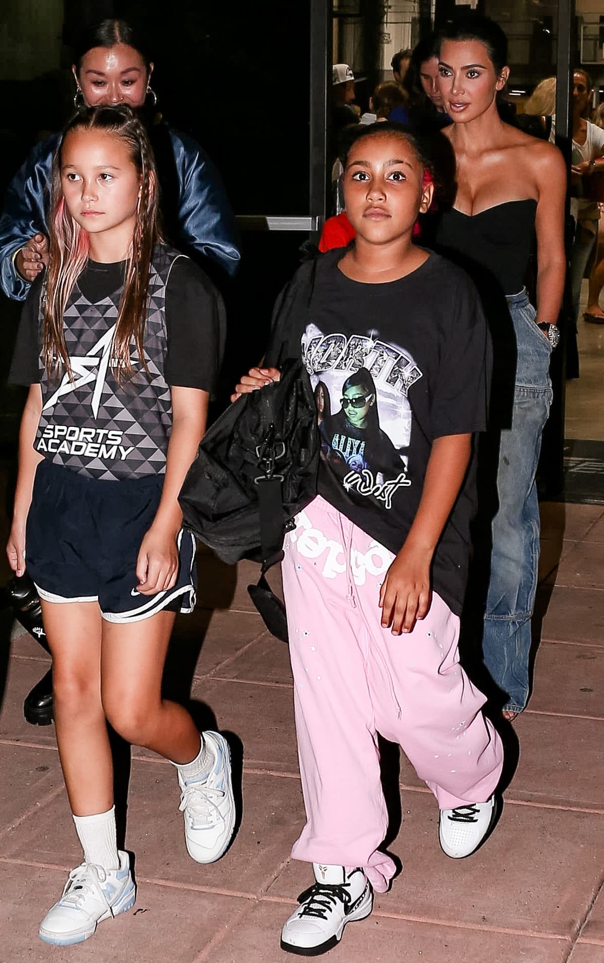 North West kept it effortlessly cool in a black graphic oversized tee paired with bubblegum-pink sweatpants, finishing her sporty streetwear vibe with classic white-and-black Nike sneakers while out in Los Angeles