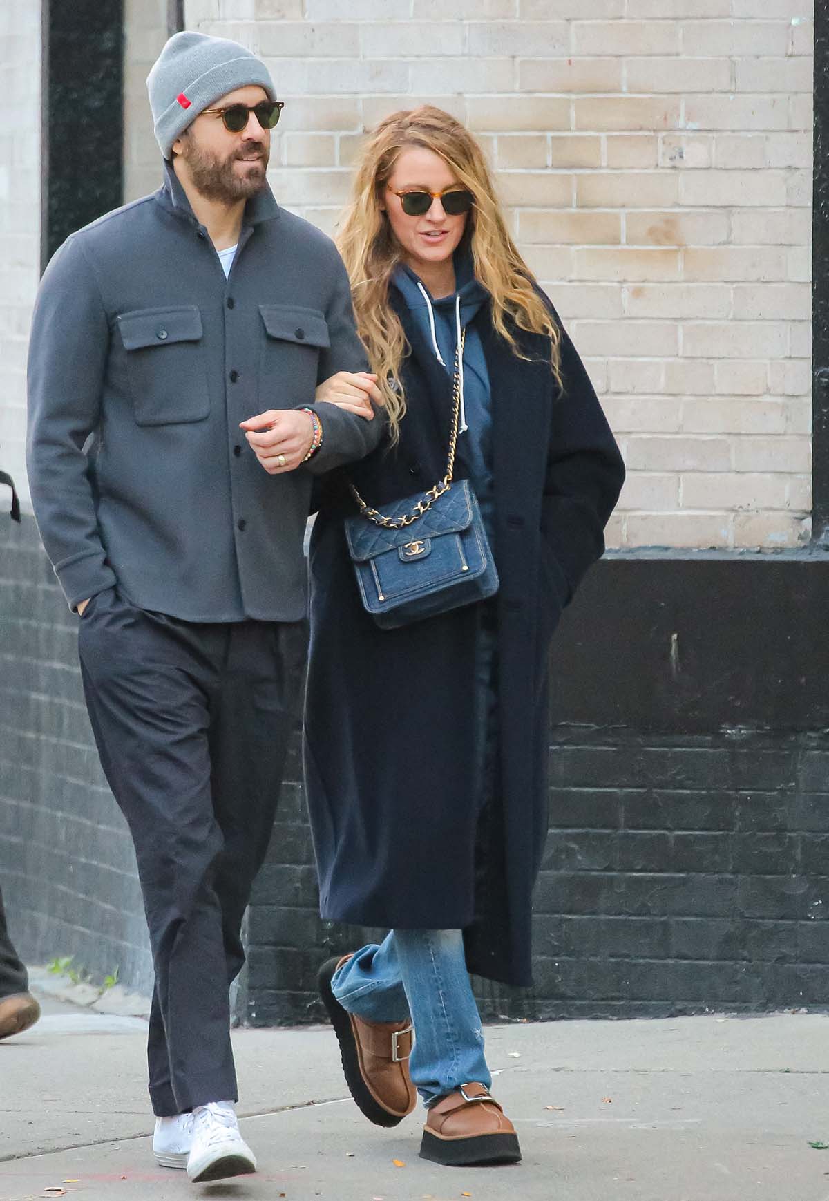 Blake Lively bundles up in a navy coat and a blue sweatshirt before completing her understated fall look with the UGG x Opening Ceremony Tasman clogs