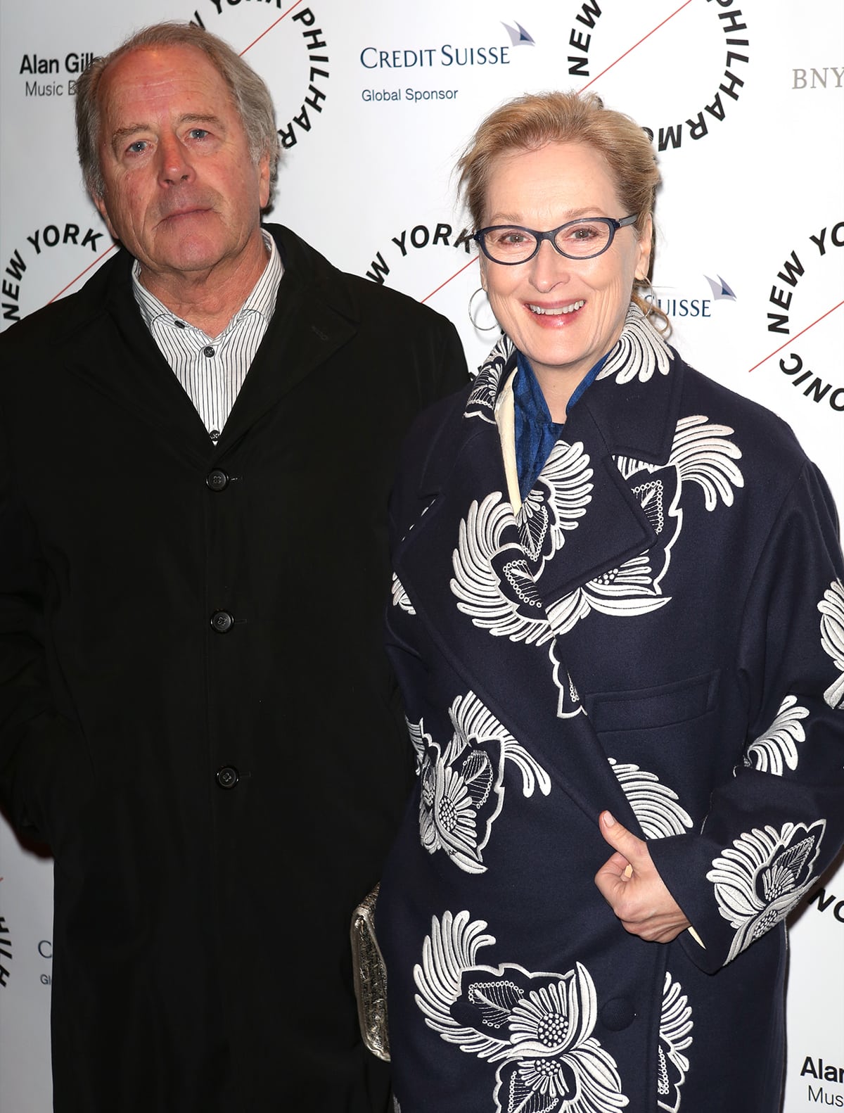 Don Gummer and Meryl Streep attend the New York Philharmonic's opening night gala of Sweeney Todd on March 5, 2014, with Streep stylishly wrapped in a navy coat adorned with bold white floral embroidery