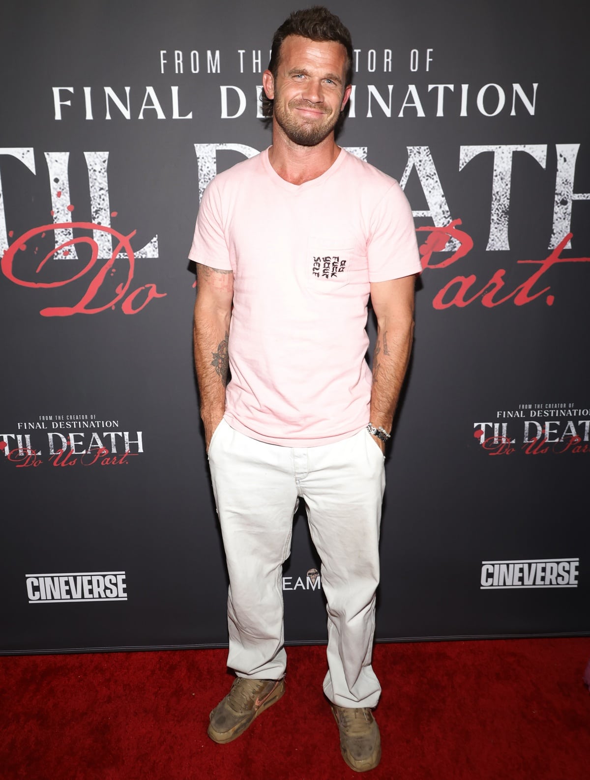 Cam Gigandet kept it effortlessly casual at the Til Death Do Us Part premiere, pairing a pastel pink graphic tee with white pants and worn-in sneakers for a laid-back red carpet look