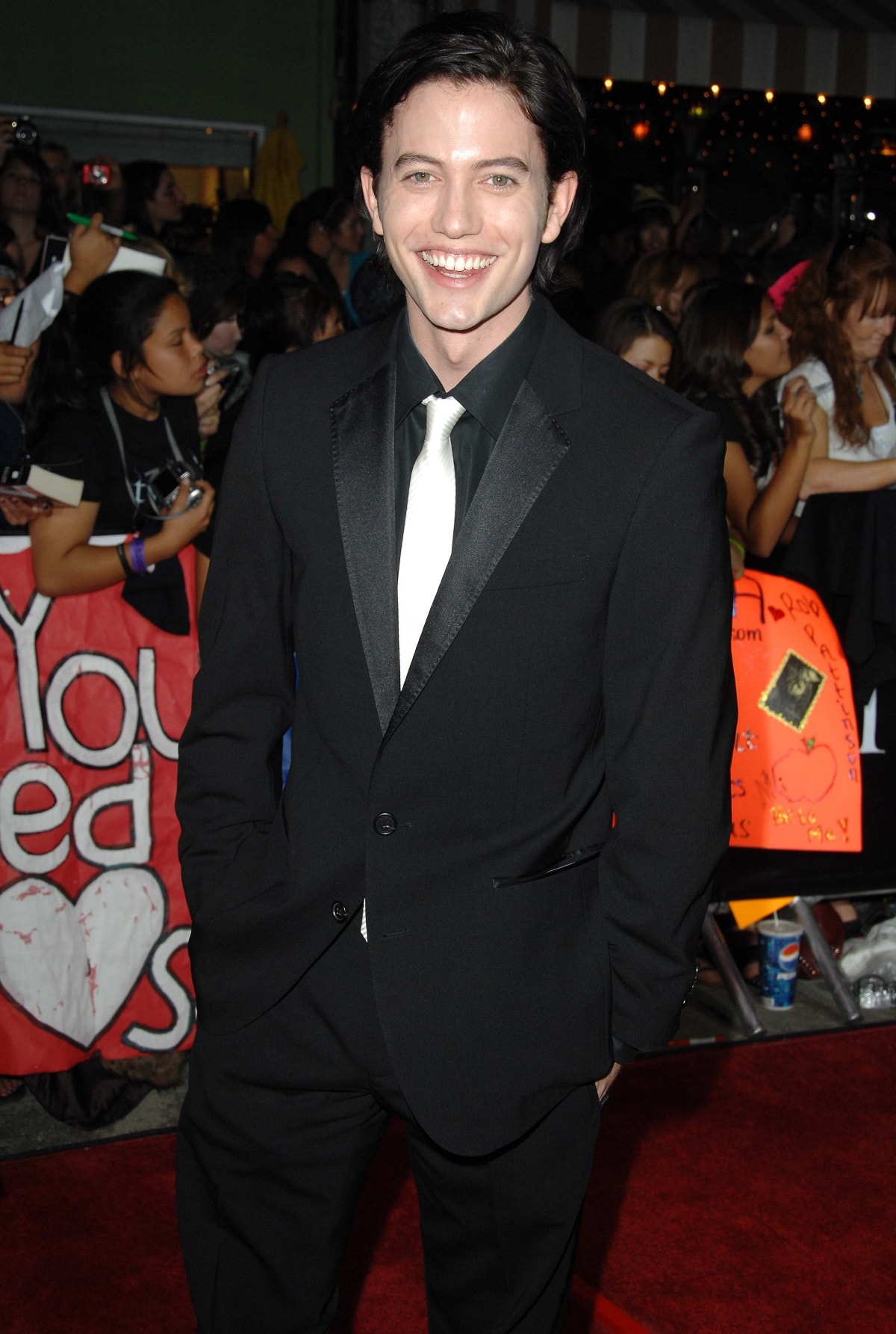 Jackson Rathbone brought classic vampire-era charm to the red carpet in a sharp black suit with satin lapels, styled with a crisp white tie and his signature megawatt smile