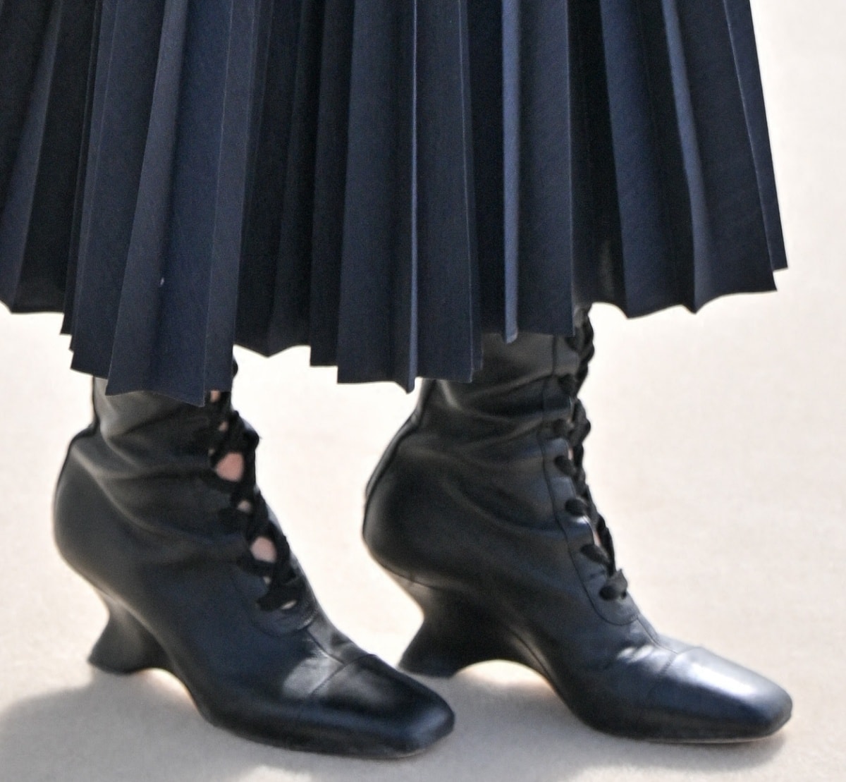 Jenna Ortega wearing black lace-up boots for a witchy vibe that complemented her business goth aesthetic