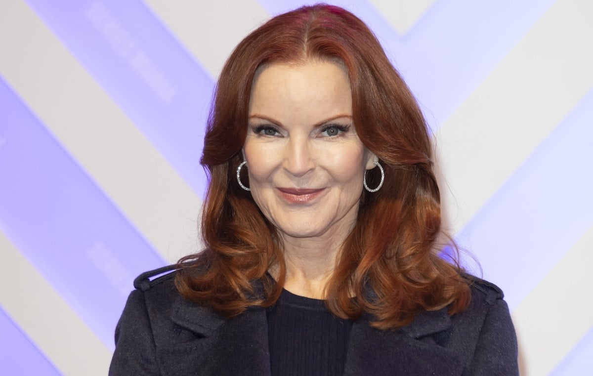 Marcia Cross's vibrant red hair perfectly frames her face, adding an elegant touch to her sophisticated ensemble, reflecting her poised and graceful demeanor