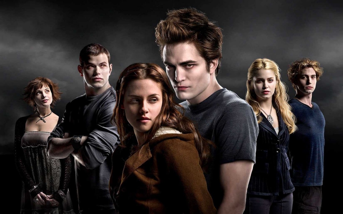 The Cullen family stands united in this iconic promotional image from Twilight, capturing the moody intensity and supernatural allure that defined the vampire saga