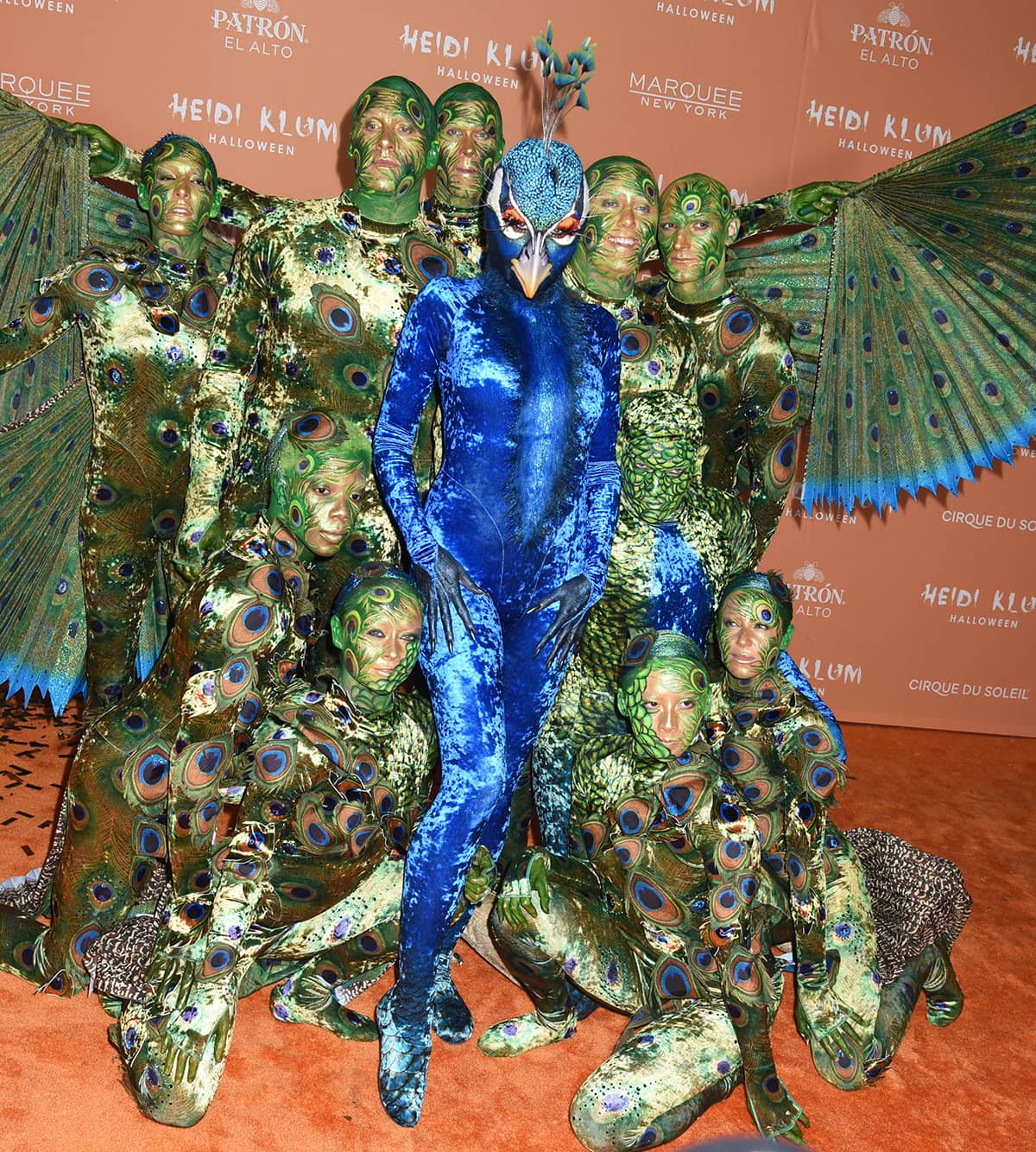 Heidi Klum stuns in a velvet cobalt blue bodysuit and custom beak headpiece, transforming into a majestic peacock flanked by ten Cirque du Soleil dancers at her 22nd Annual Halloween Party at Marquee New York on October 31, 2023