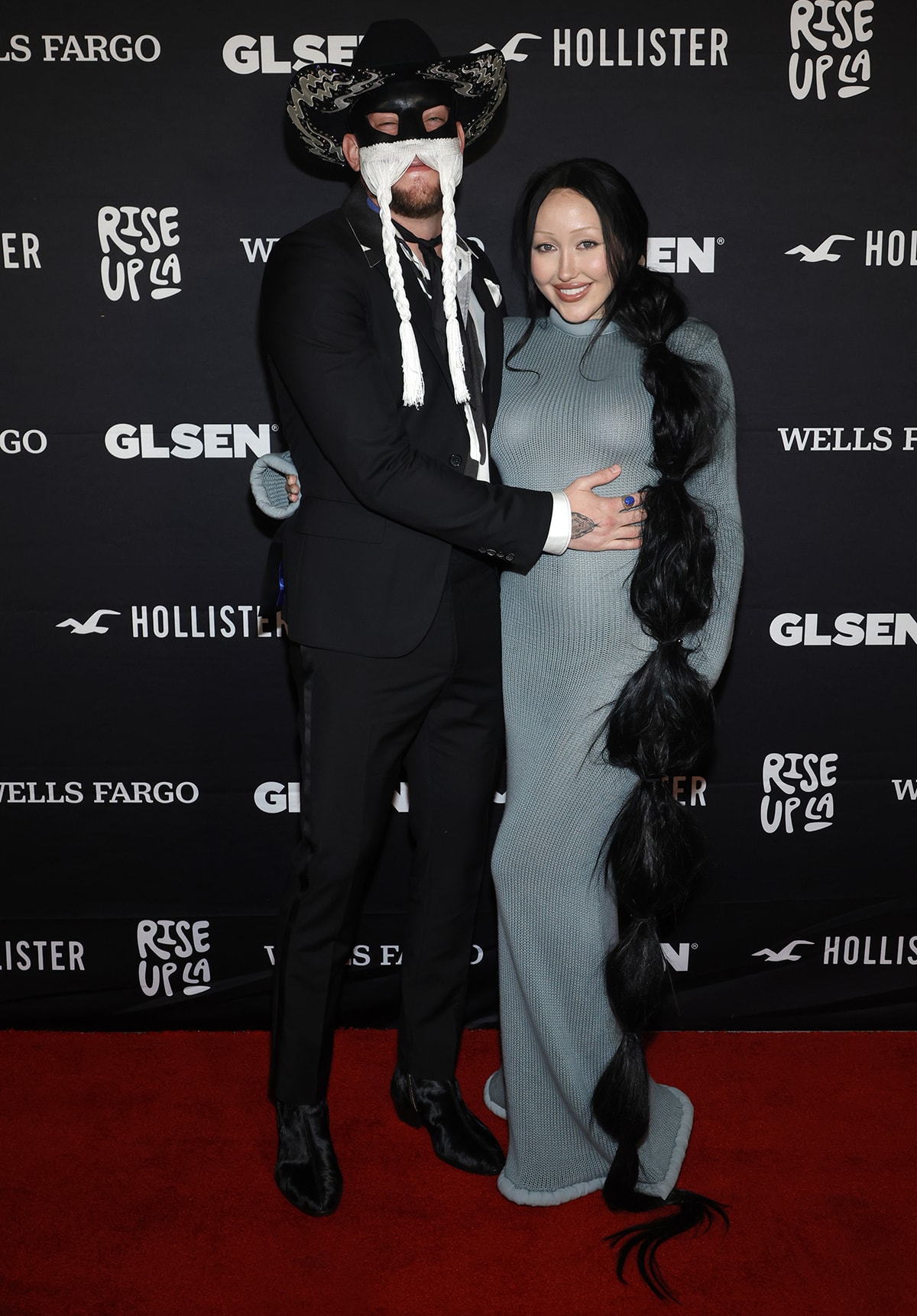 Noah Cyrus posing with country musician Orville Peck, who was honored with the Champion Award at the event