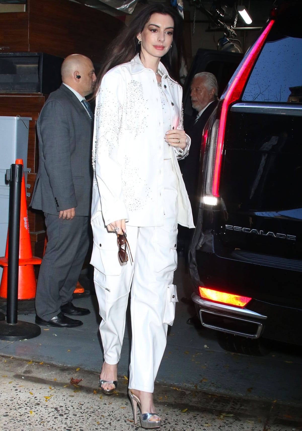 Anne Hathaway finished her monochromatic outfit with metallic silver Jimmy Choo high-heeled sandals that subtly elongated the relaxed denim silhouette