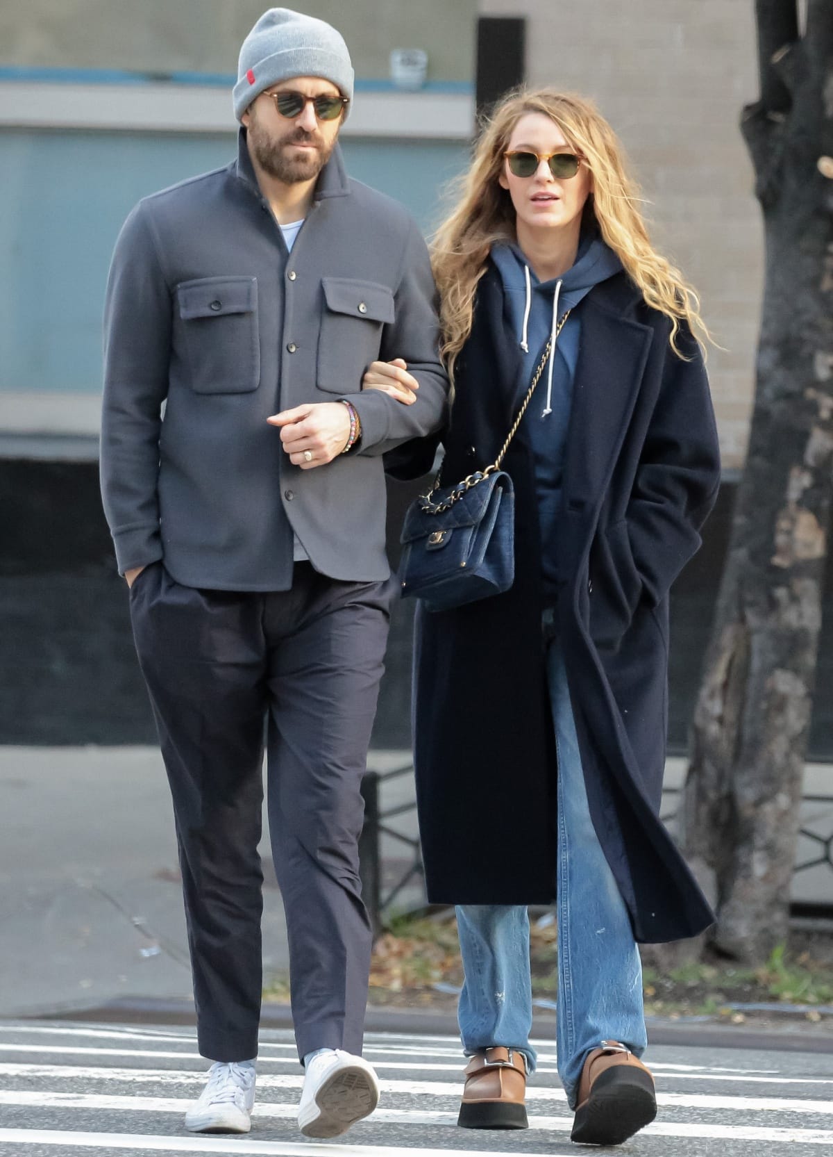 Ryan Reynolds and Blake Lively coordinated effortlessly while out in New York City on October 24, 2023, grounding their layered fall looks with casual sneakers and chunky platform clogs that balanced comfort with polished street style