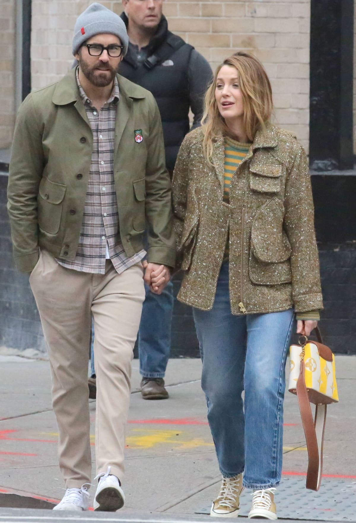 Ryan Reynolds and Blake Lively hold hands in NYC on November 10, 2023, with Blake adding a pop of color in pastel yellow high-top Converse sneakers while Ryan keeps it classic in clean white trainers