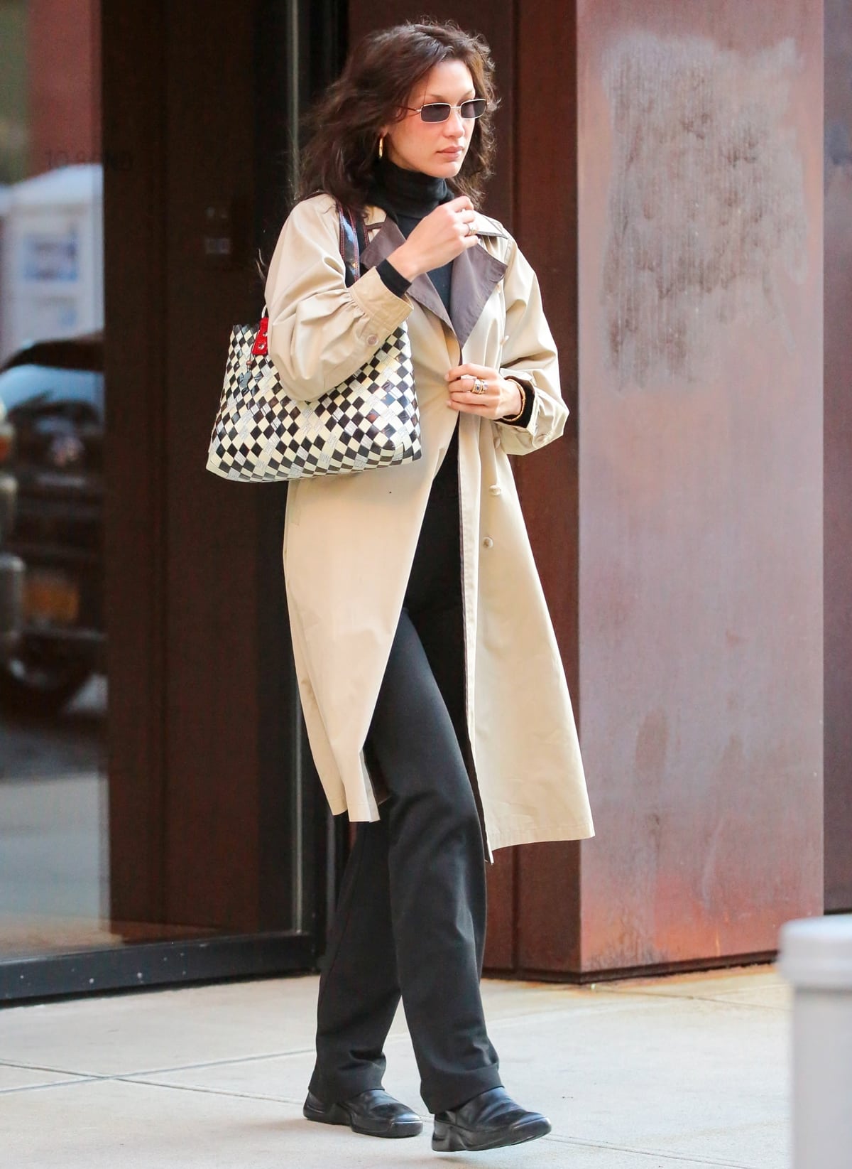 Bella Hadid steps out in style, showcasing her minimalist fashion evolution with a sleek black turtleneck and wide-leg trousers