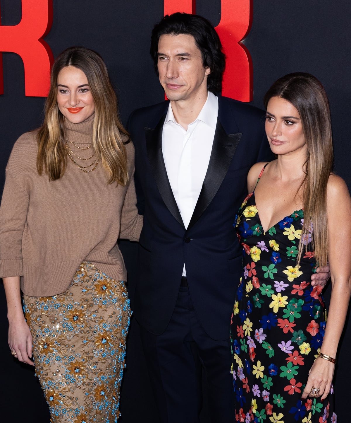 Adam Driver, standing tall at 6ft 2 ¼ inches (188.6 cm), towers over Penélope Cruz (5ft 4 inches, 162.6 cm) and Shailene Woodley (5ft 7 ¾ inches, 172.1 cm) on the red carpet, highlighting the striking height difference among the 'Ferrari' film's stars
